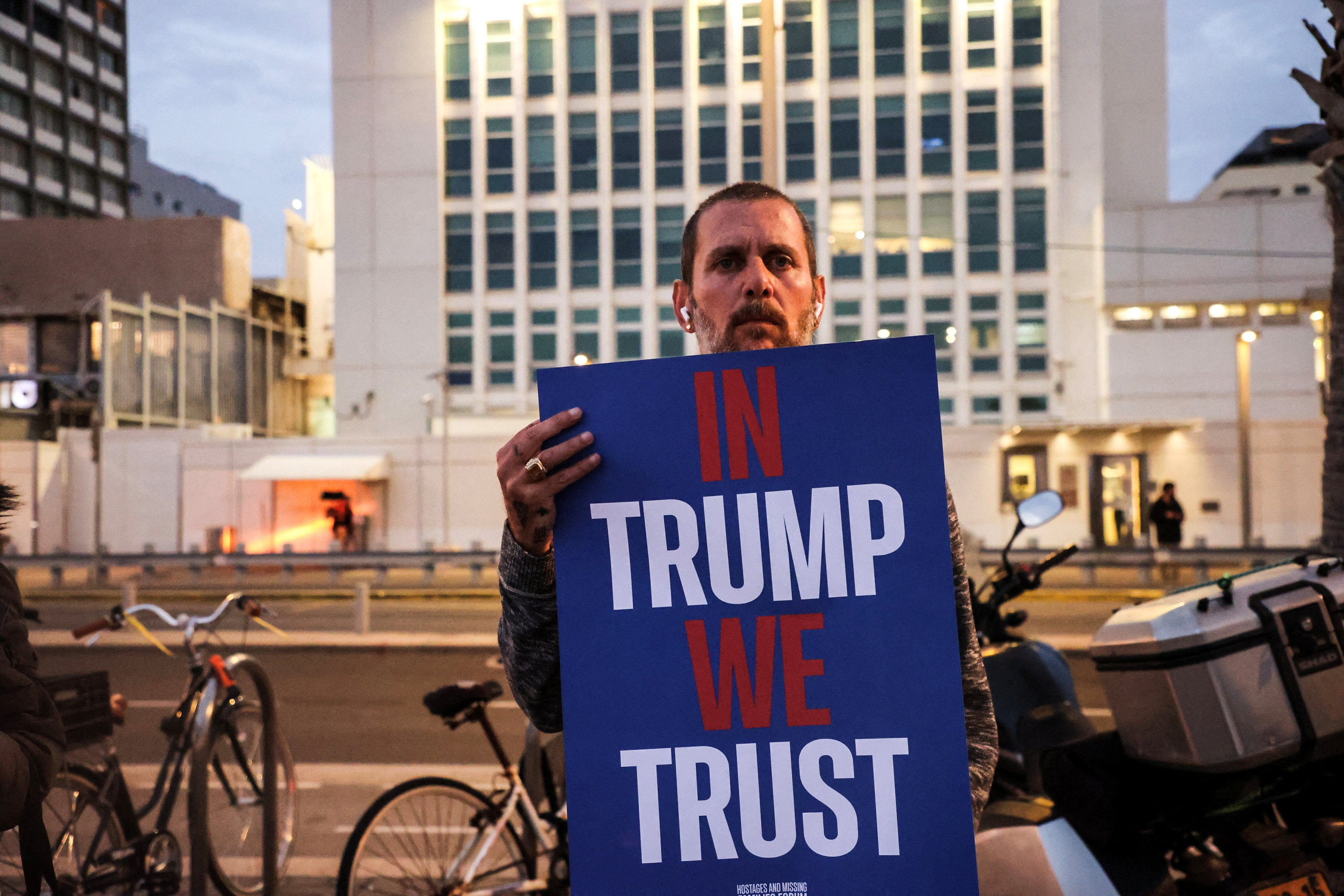 A protester holds a placard demanding the return of all hostages held in Gaza, outside the US consulate in Tel Aviv, Israel on Monday. Photo: Reuters