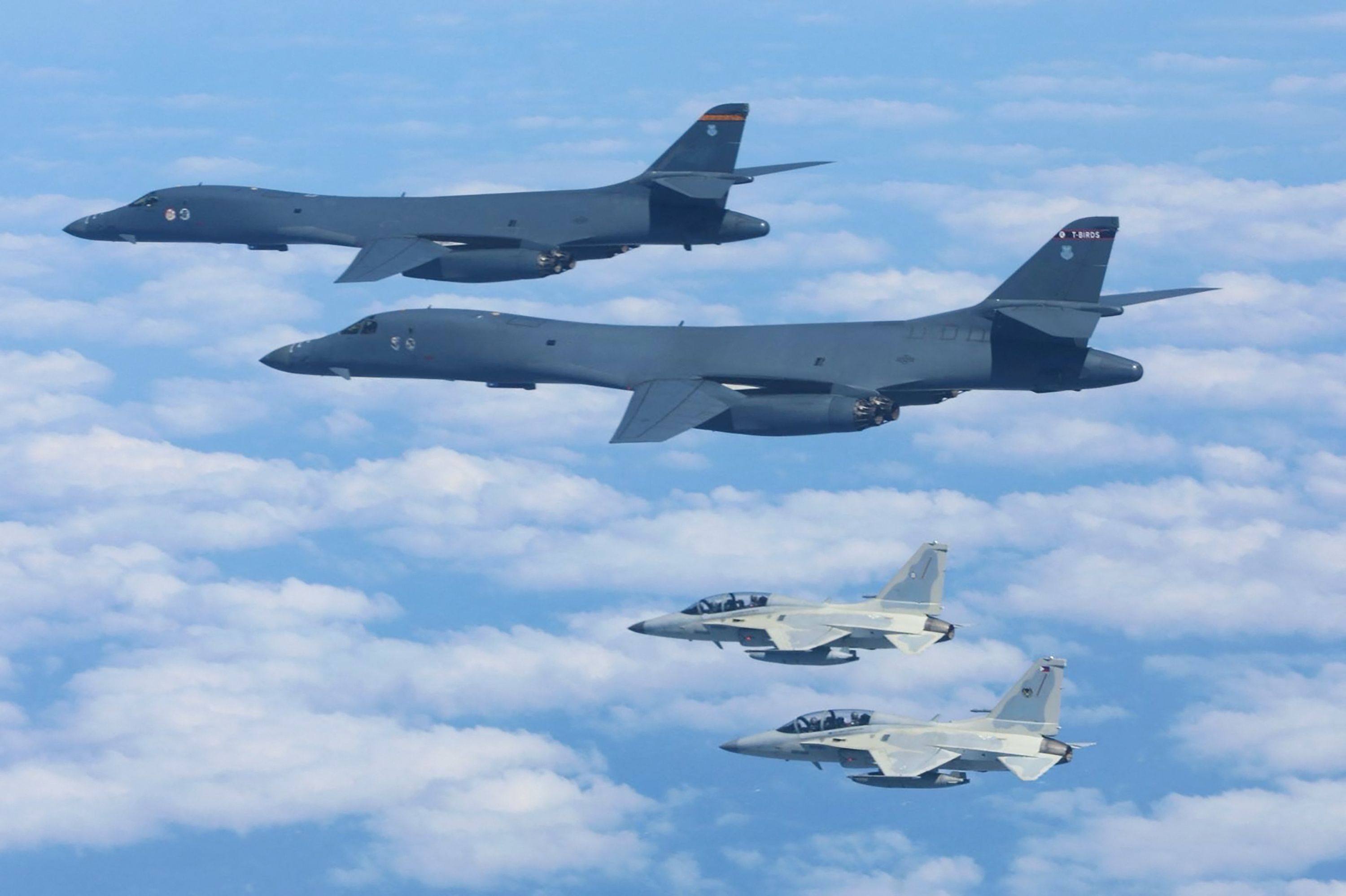 A pair of PAF FA-50 fighter aircraft (foreground) in formation flight with a pair of US Air Force B-1B bombers during a joint air exercise over the South China Sea on Tuesday. Photo: Philippine Air Force / AFP