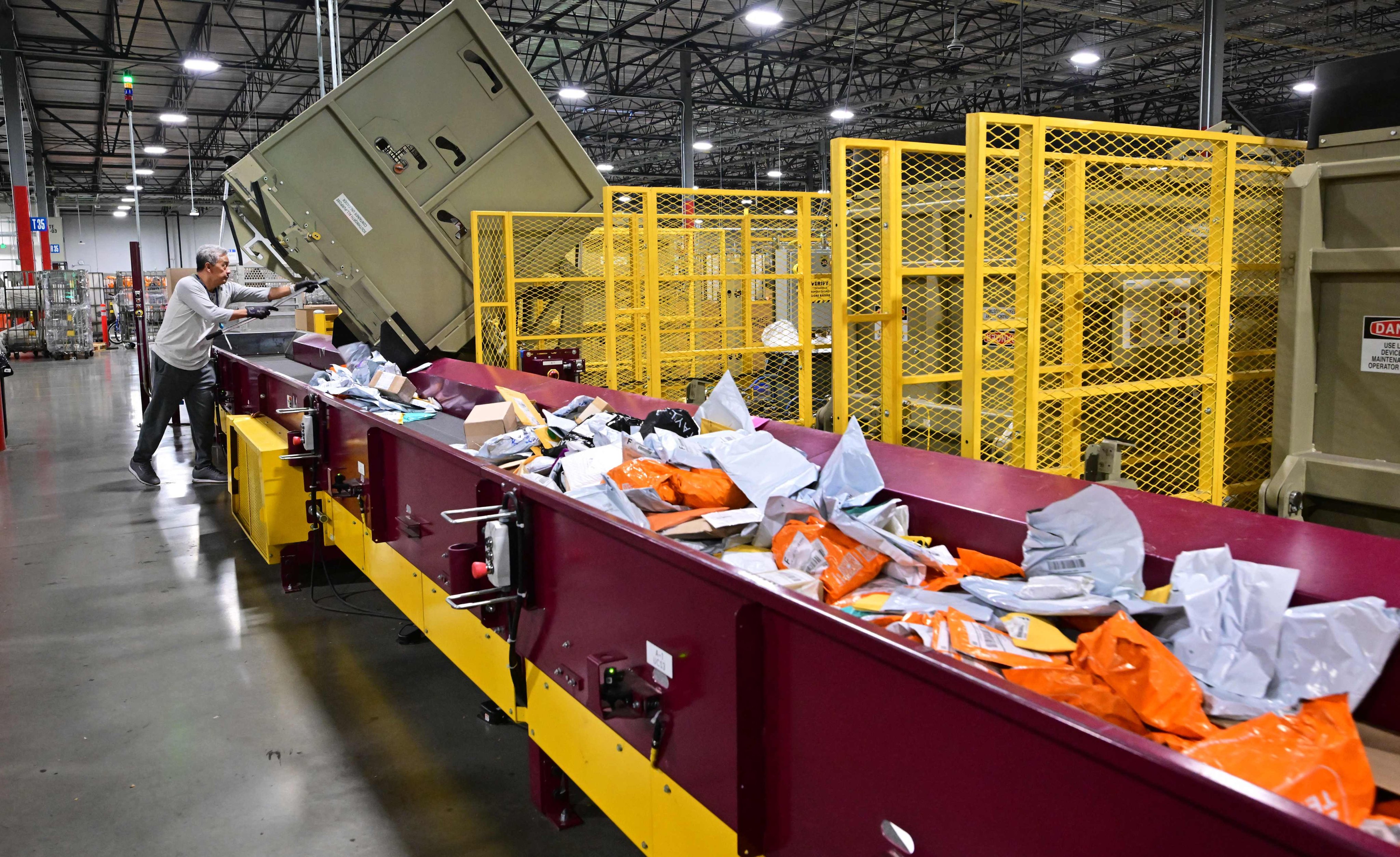 A US Postal Service employee sorts mail at a processing and distribution centre in Los Angeles. Photo: AFP