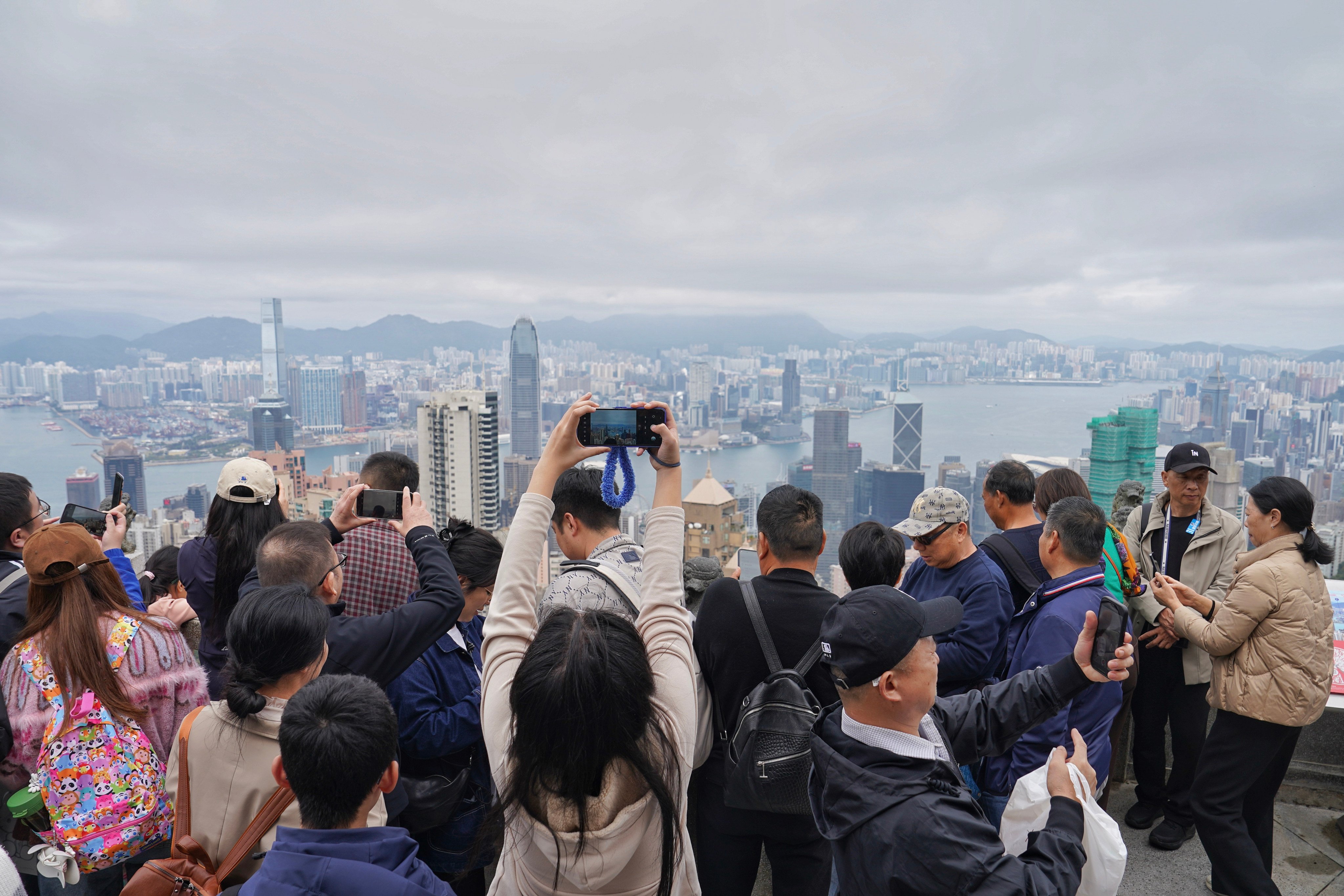 Visitors to The Peak snap photos of Hong Kong’s skyline over the Lunar New Year holiday. Photo: Elson Li