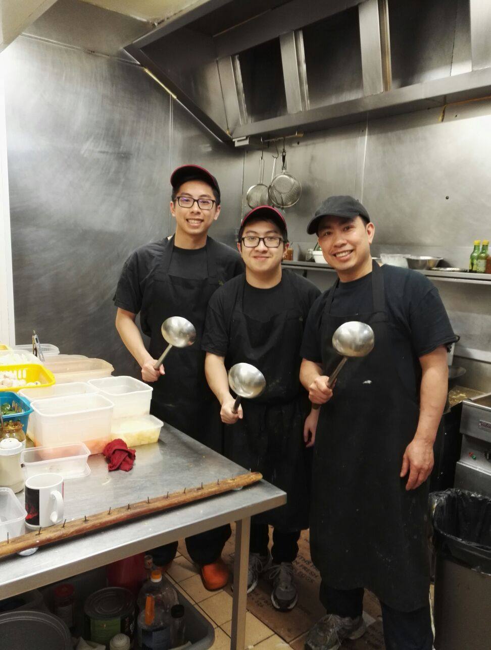 (From left) Writer Ginny Wong’s cousin, younger brother and uncle pose for a photo at her uncle’s takeaway in England in 2017. Photo: Courtesy of the Wong family