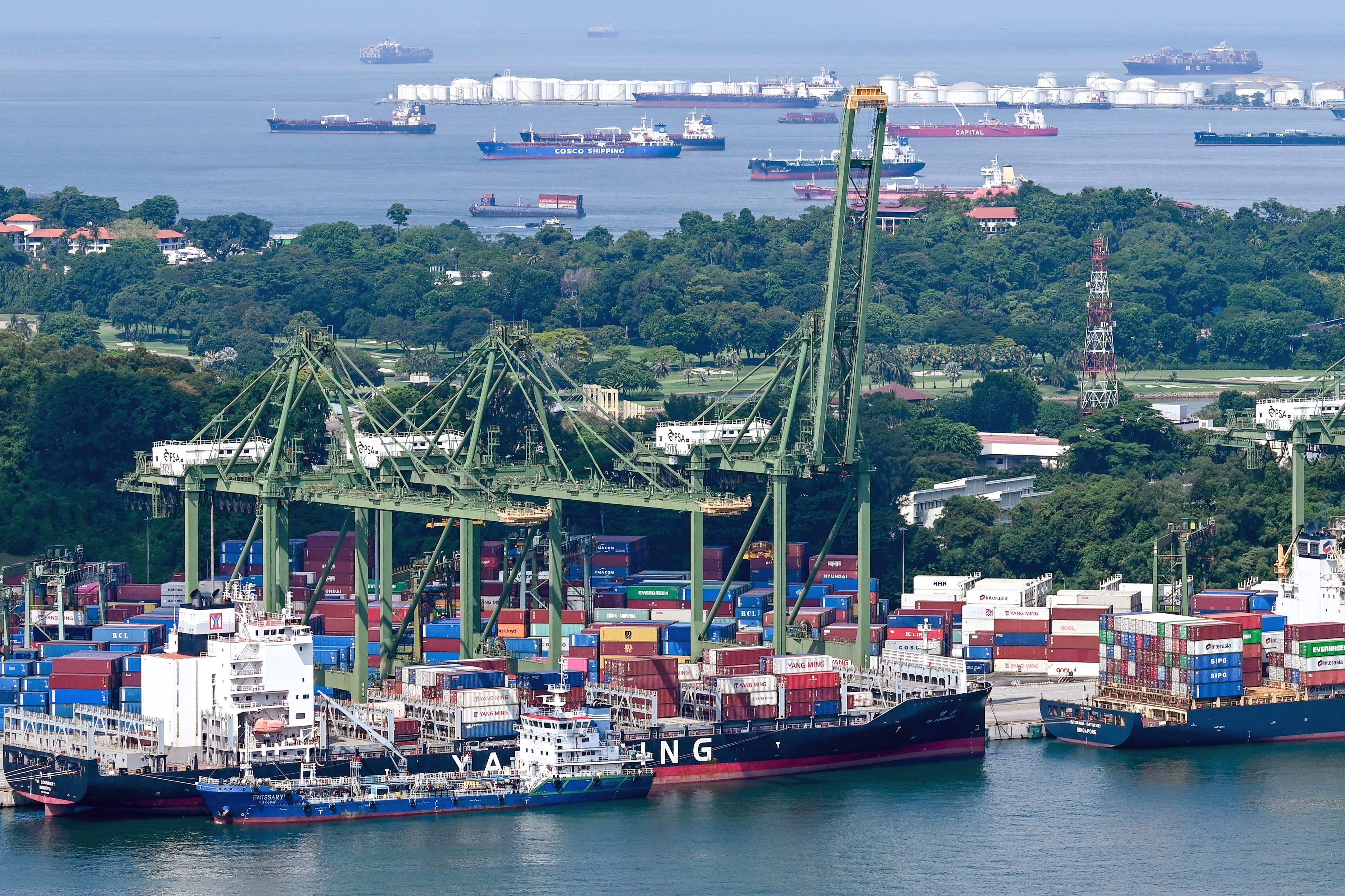 Vessels docked next to containers stacked at the Pulau Brani port terminal in Singapore. Photo: AFP