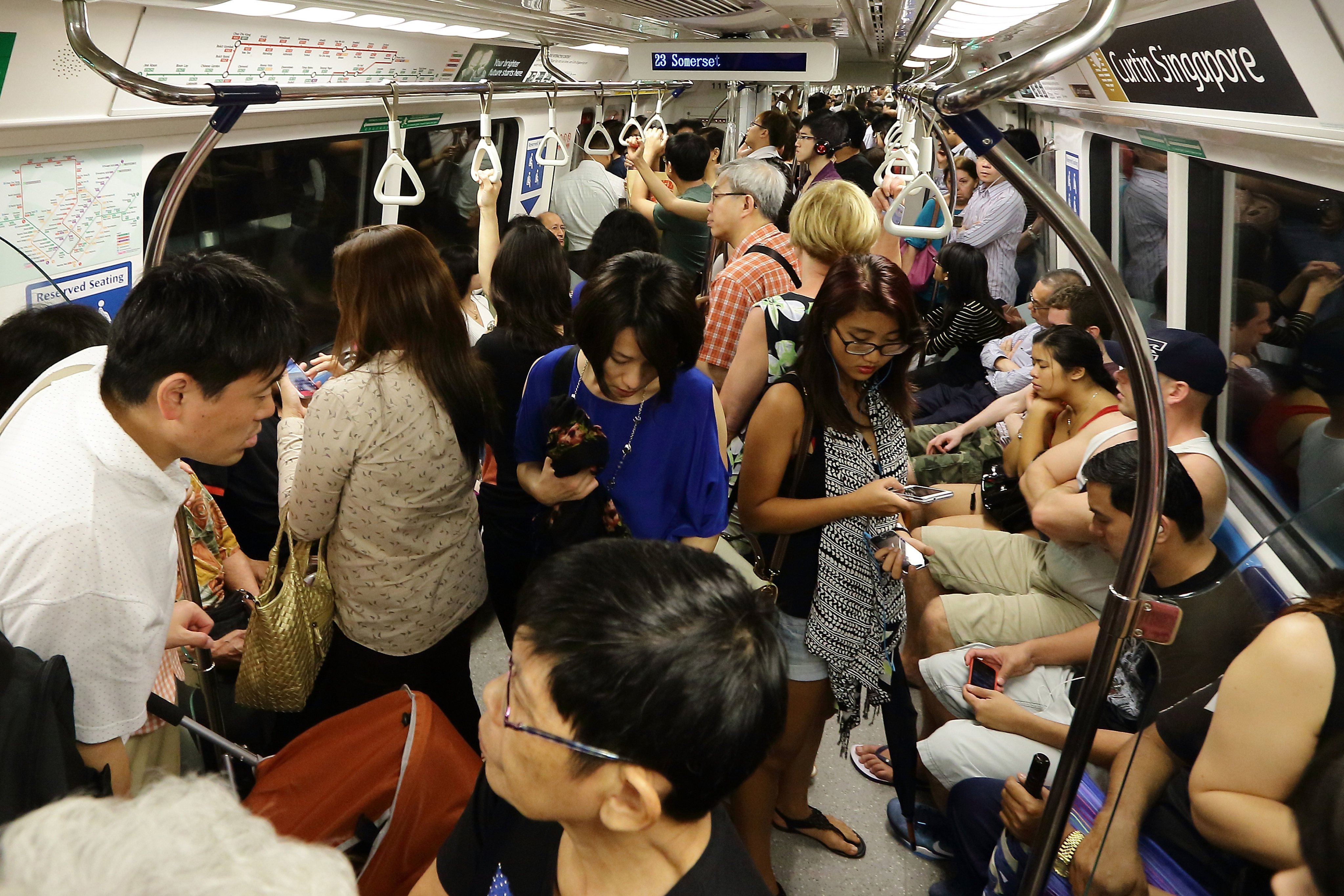 Commuters pack a train in Singapore. A recent post about the smell of sweaty bodies during a morning commute ignited fierce debate on social media in the country. Yet hot running water piped to one’s home is a relatively recent invention. Before that, few bathed daily. Photo: 
 Suhaimi Abdullah/Getty Images