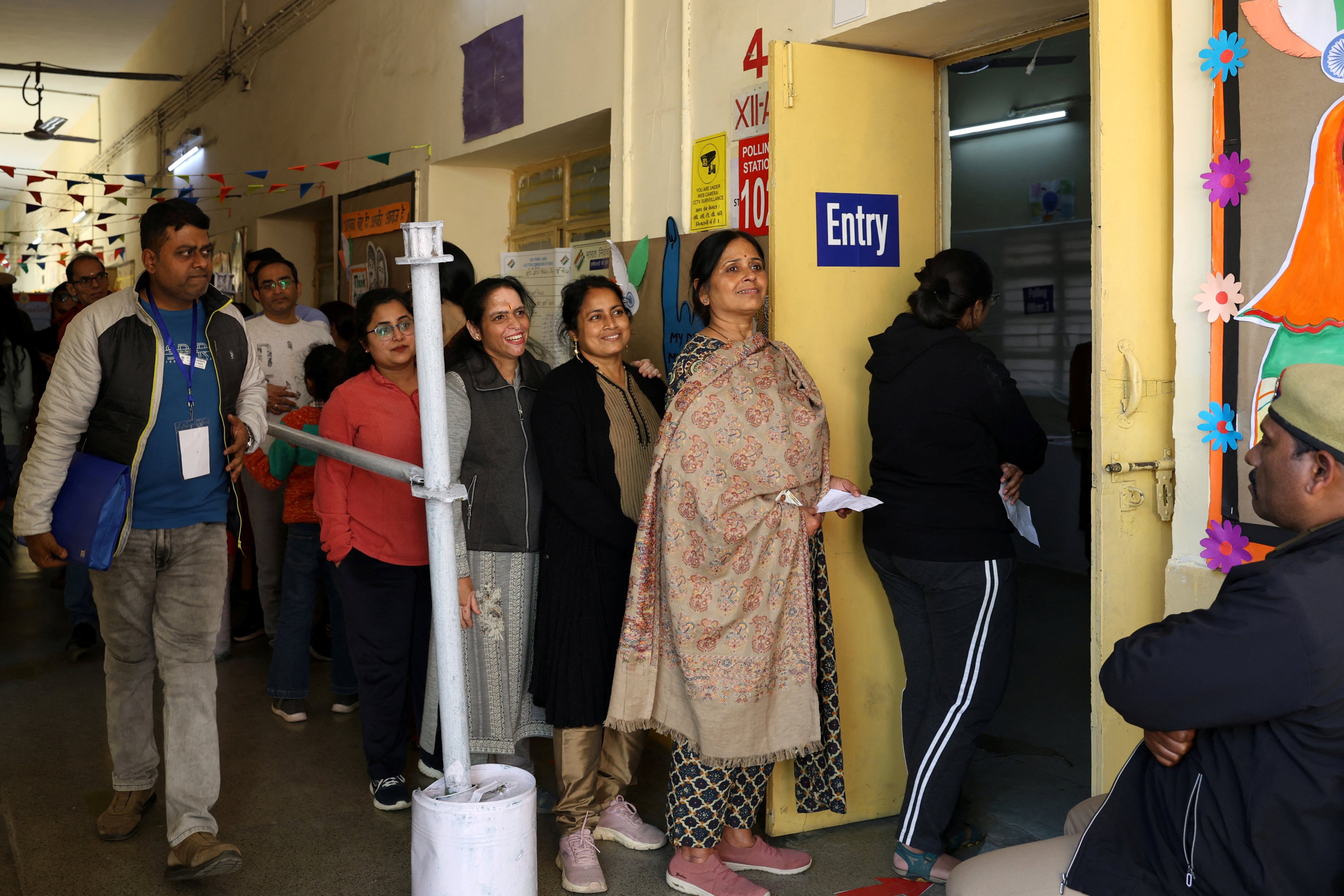 People queue to vote at a polling station in the state assembly election in New Delhi, India, on Wednesday. Photo: Reuters