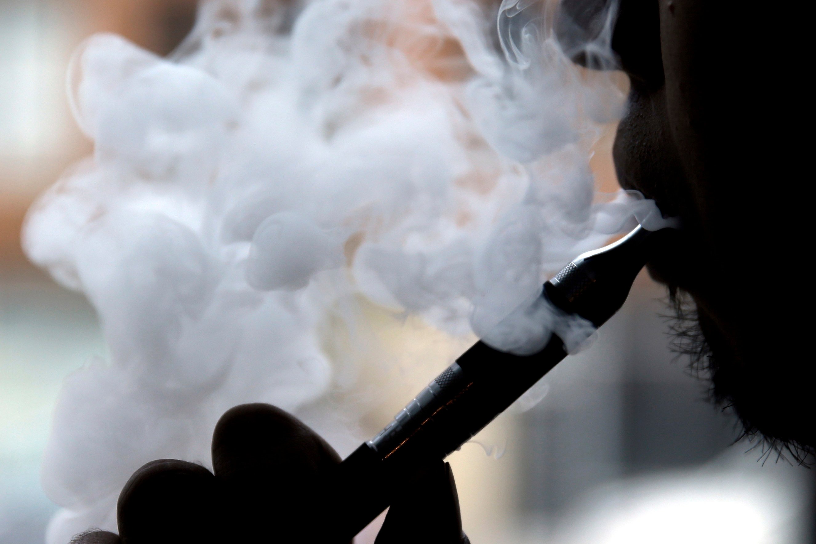 A man smokes an electronic cigarette. Photo: AP