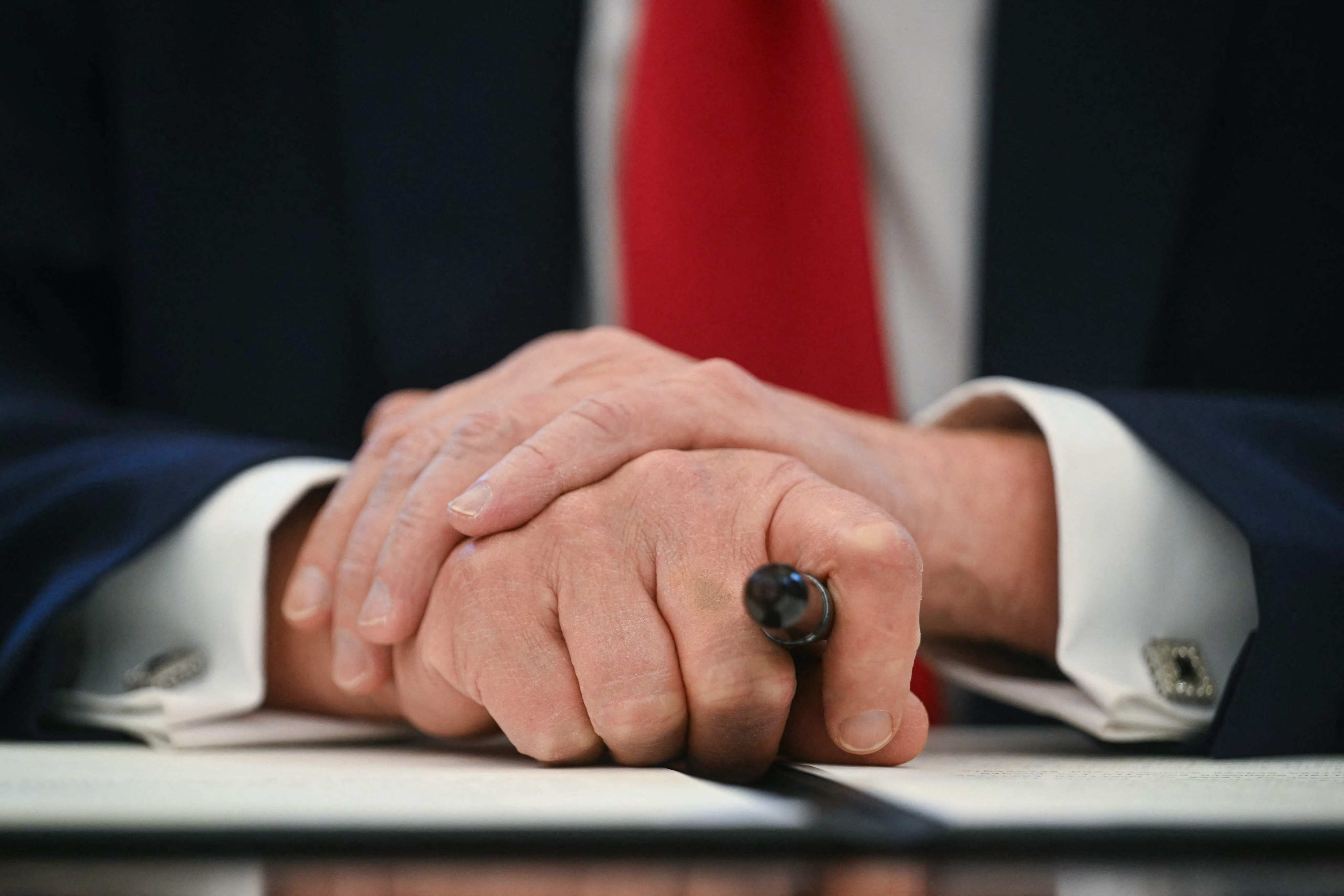 US President Donald Trump holds a marker as he signs an executive order to create a US sovereign wealth fund, in the Oval Office of the White House on February 3, in Washington, DC. As of February 5, Trump has issued 80 executive actions, including executive orders, proclamations and memos, according to the CNN. Photo: AFP 