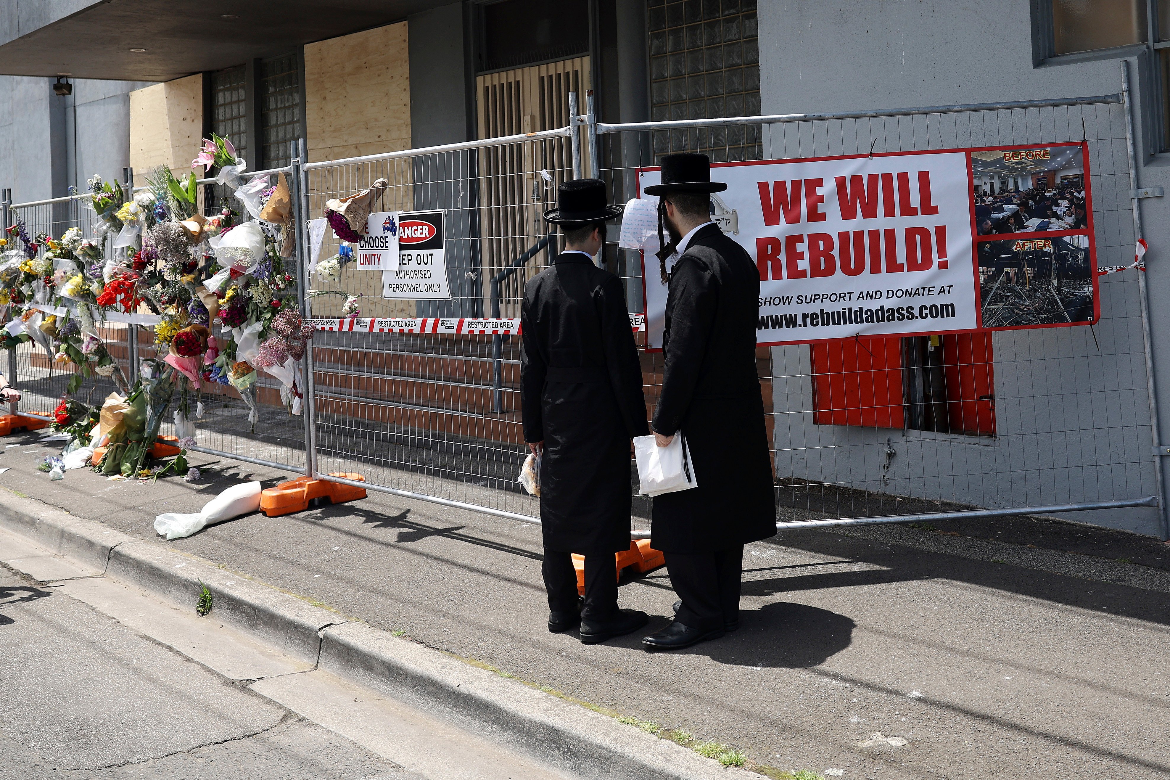 Men stand outside the Adass Israel Synagogue after a firebombing in Melbourne in December 2024. Photo: AP