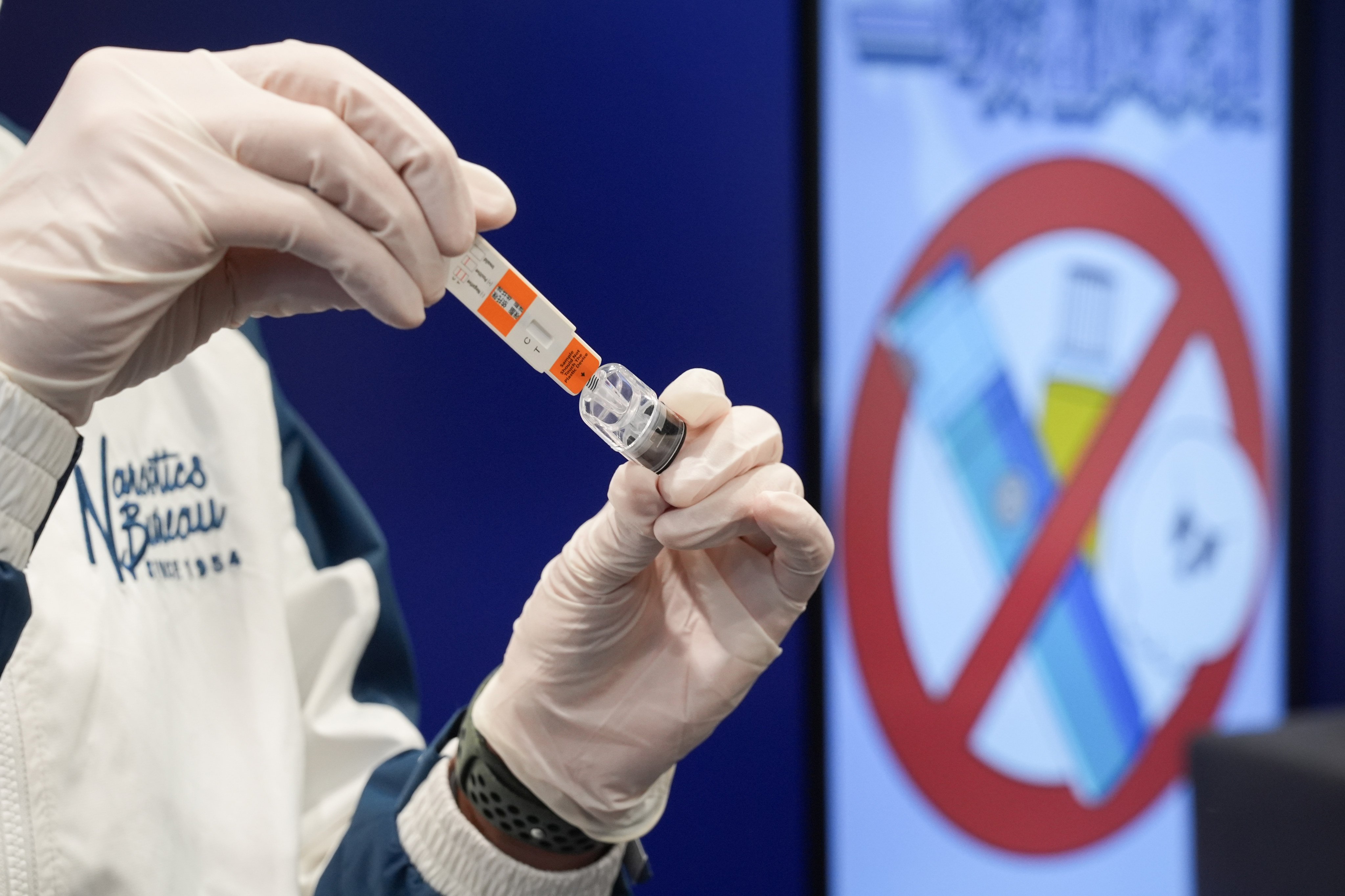 A police officer demonstrates the “space oil” rapid test. Photo: Eugene Lee