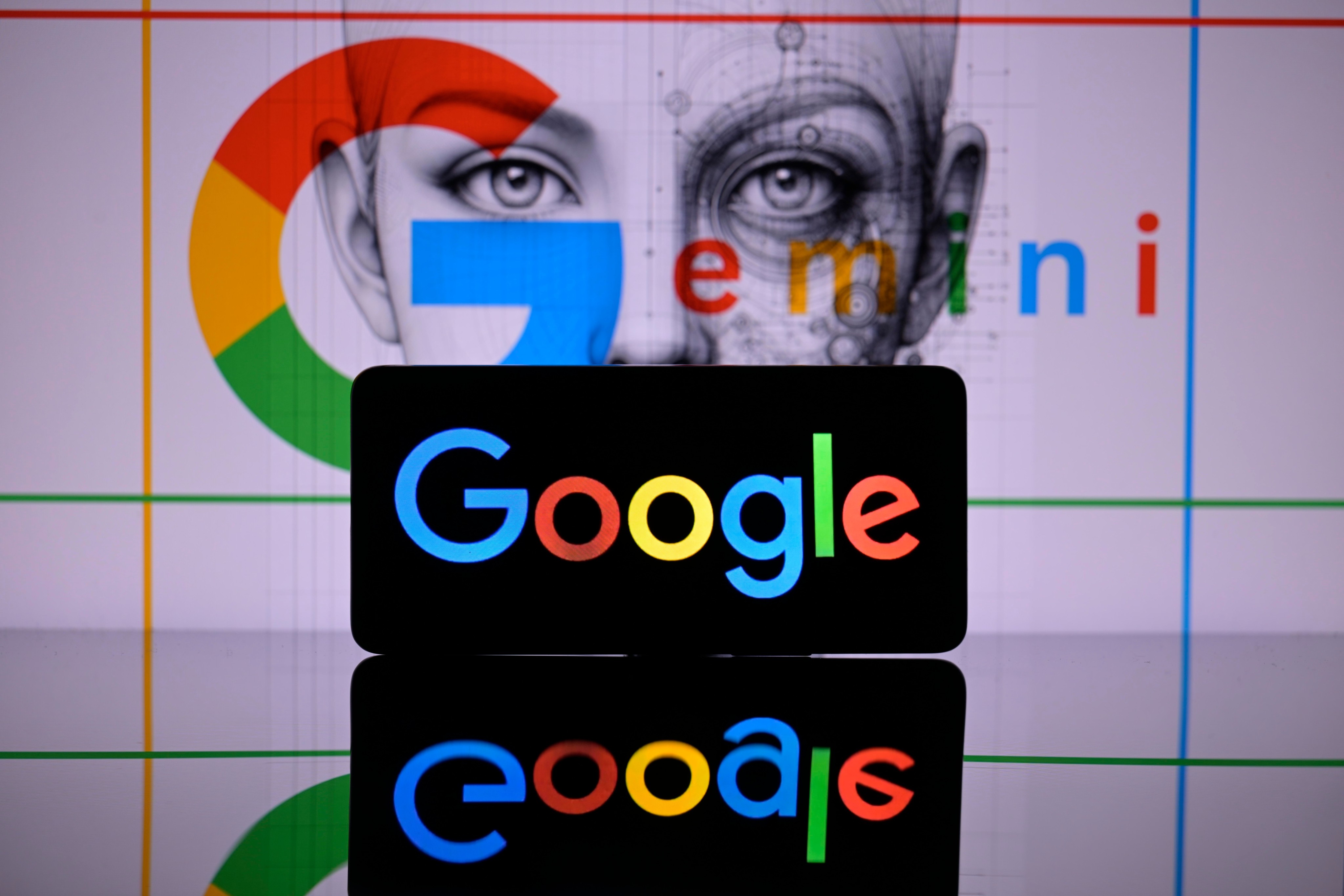 The Google logo is displayed on a smartphone with Google Gemini seen in the background. Photo: Shutterstock Images