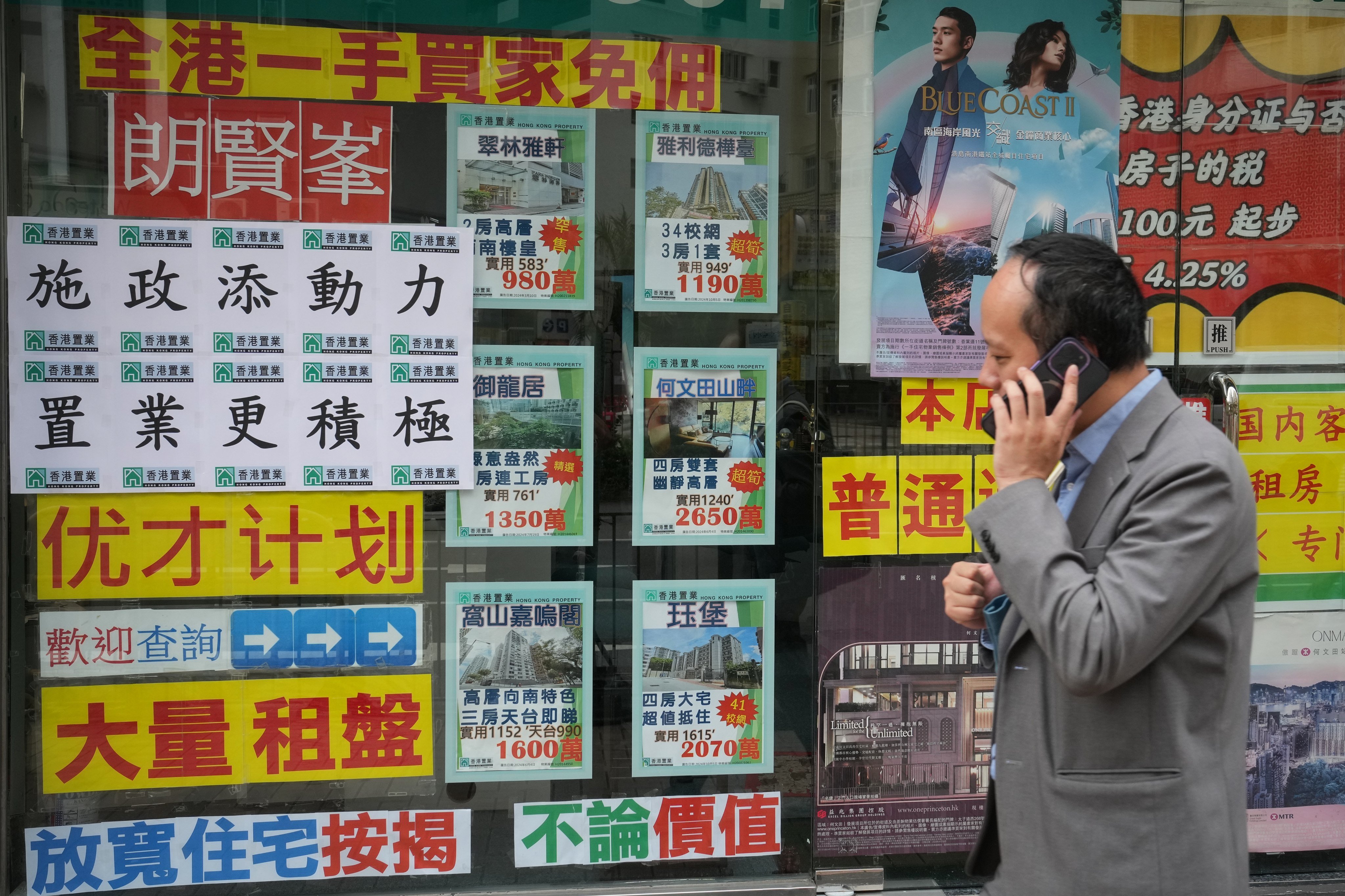 A man passes a property agency in Mong Kok. Photo: Elson Li