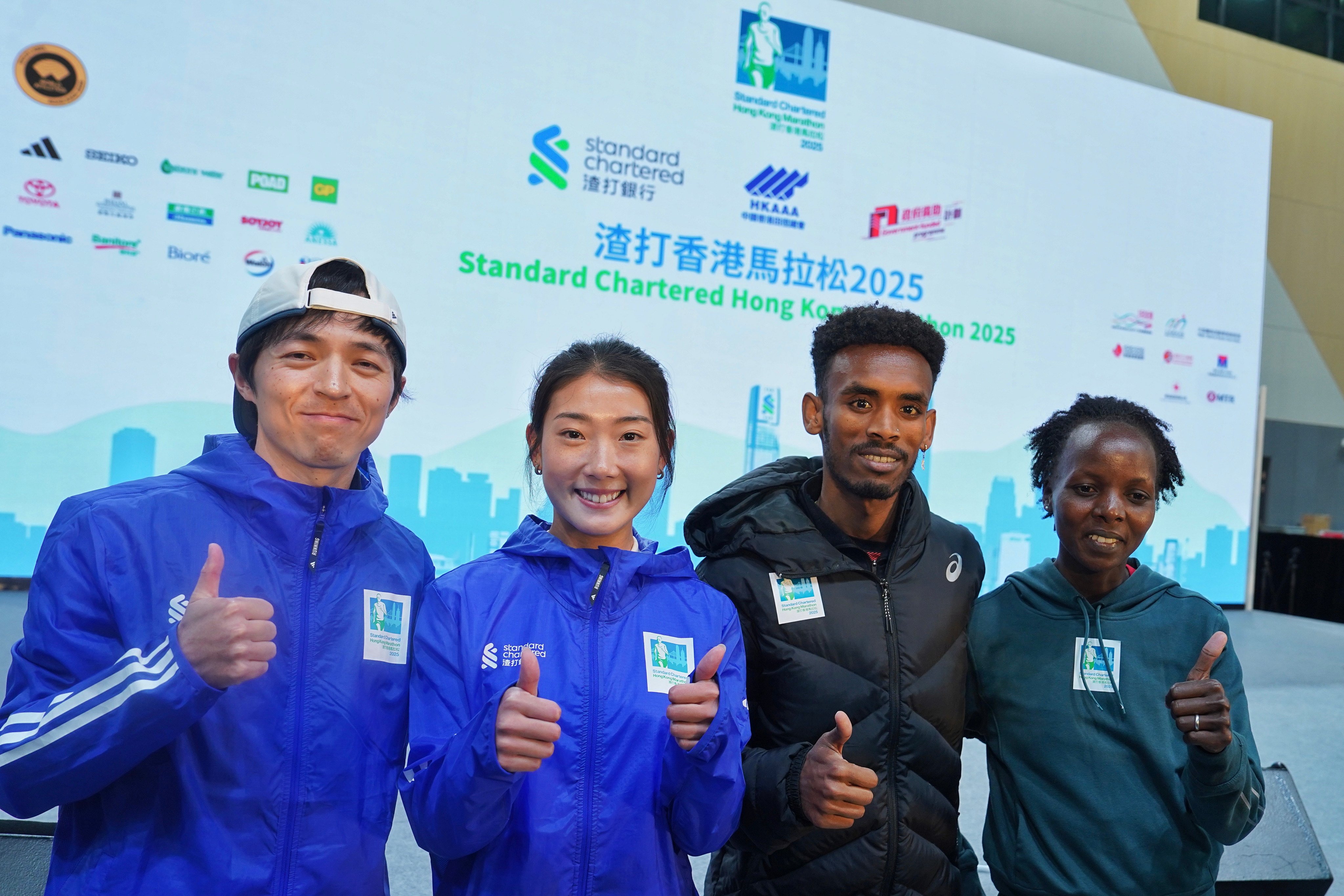 From left, Hong Kong’s Ngai Kang and Virginia Lo at the Standard Chartered Hong Kong Marathon 2025 press conference with race favourites Gashau Ayale of Israel and Kenyan-born Bahraini Rose Chelimo. Photo: Elson Li