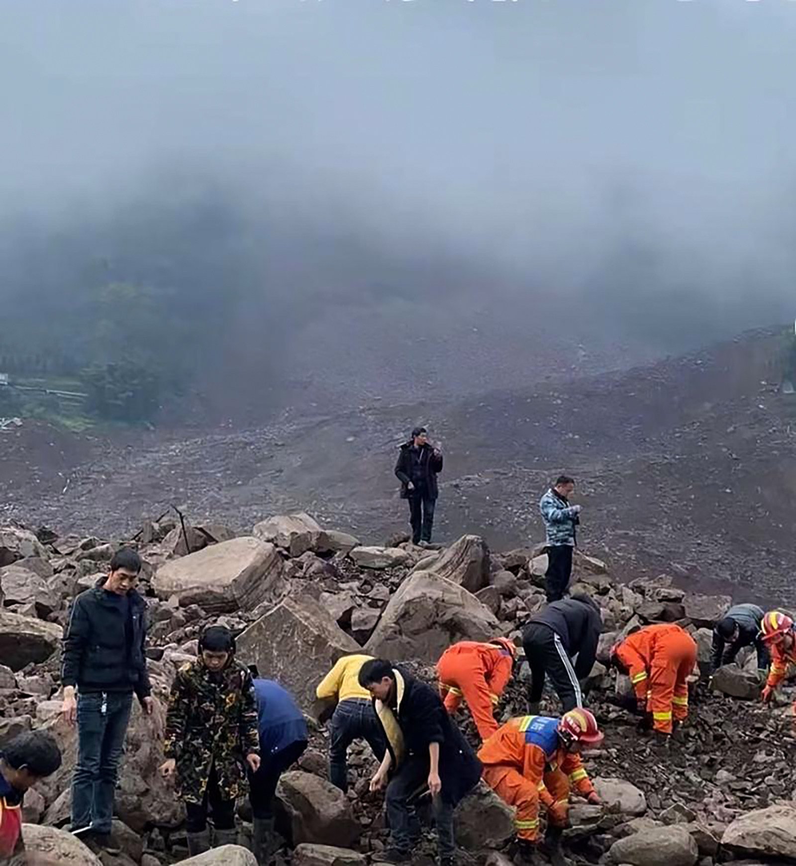 Emergency workers search the site of a landslide in Jinping, Sichuan province, on Saturday. Photo: Weibo