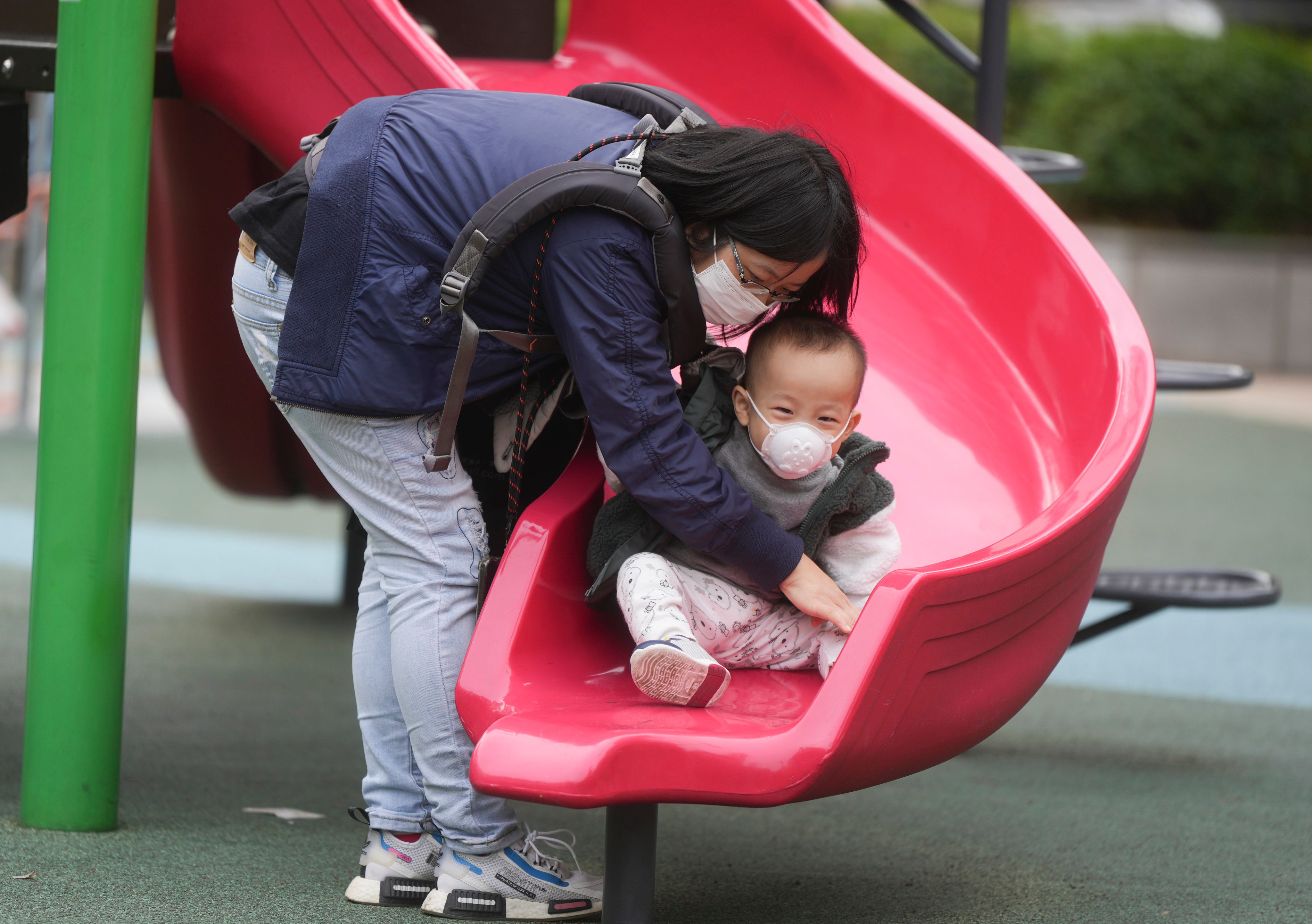 A woman and a child wear masks at a playground. Since the start of the flu season in January, the city has recorded 240 severe cases, with 90 per cent of the adult ones involving people aged 65 and above. Photo: Sam Tsang