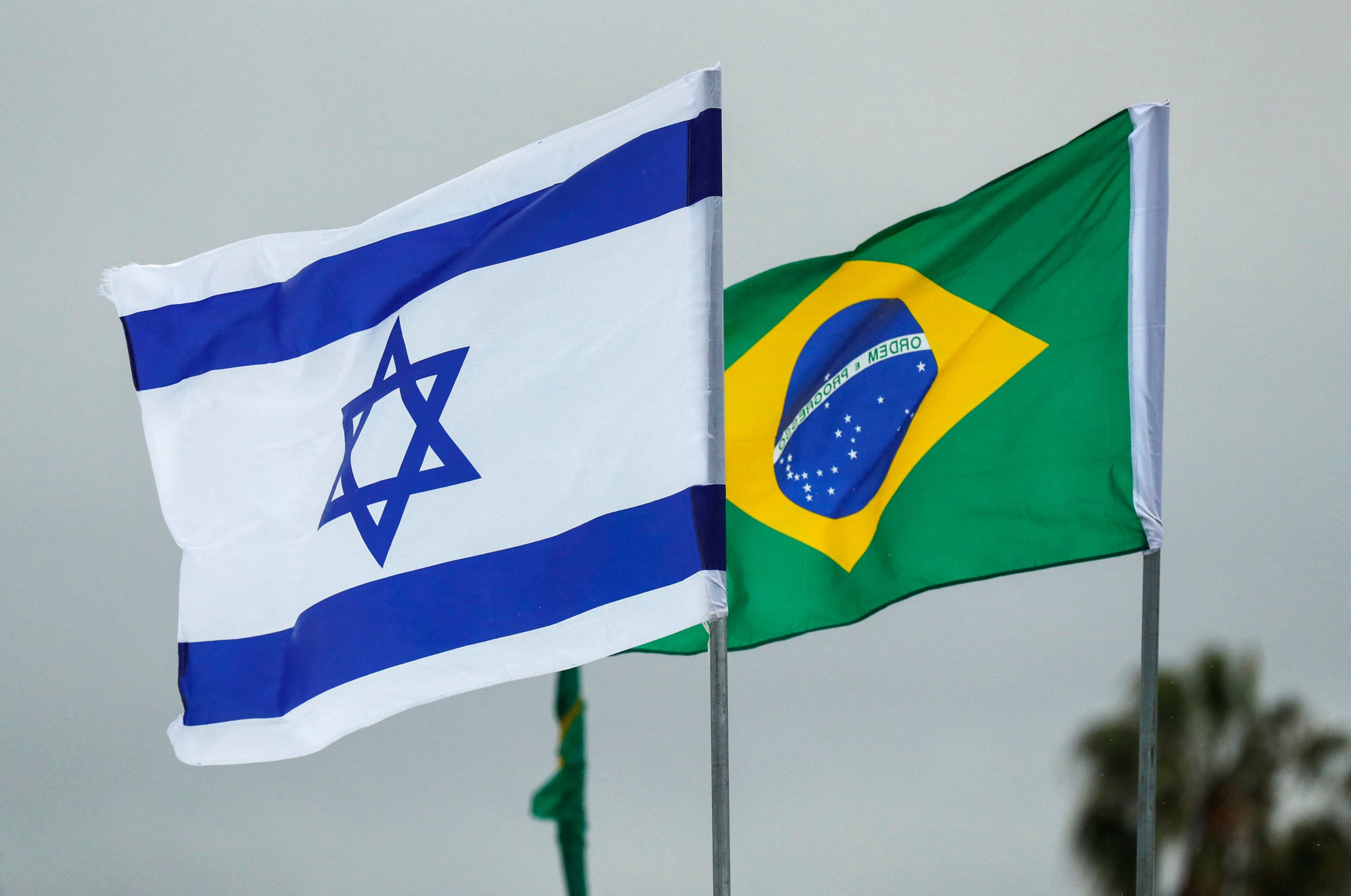 The flags of Israel and Brazil flying together at Tel Aviv Ben Gurion International Airport. An Israeli combat reservist was told by his government to flee Brazil and possible prosecution for war crimes in Gaza. Photo: AFP