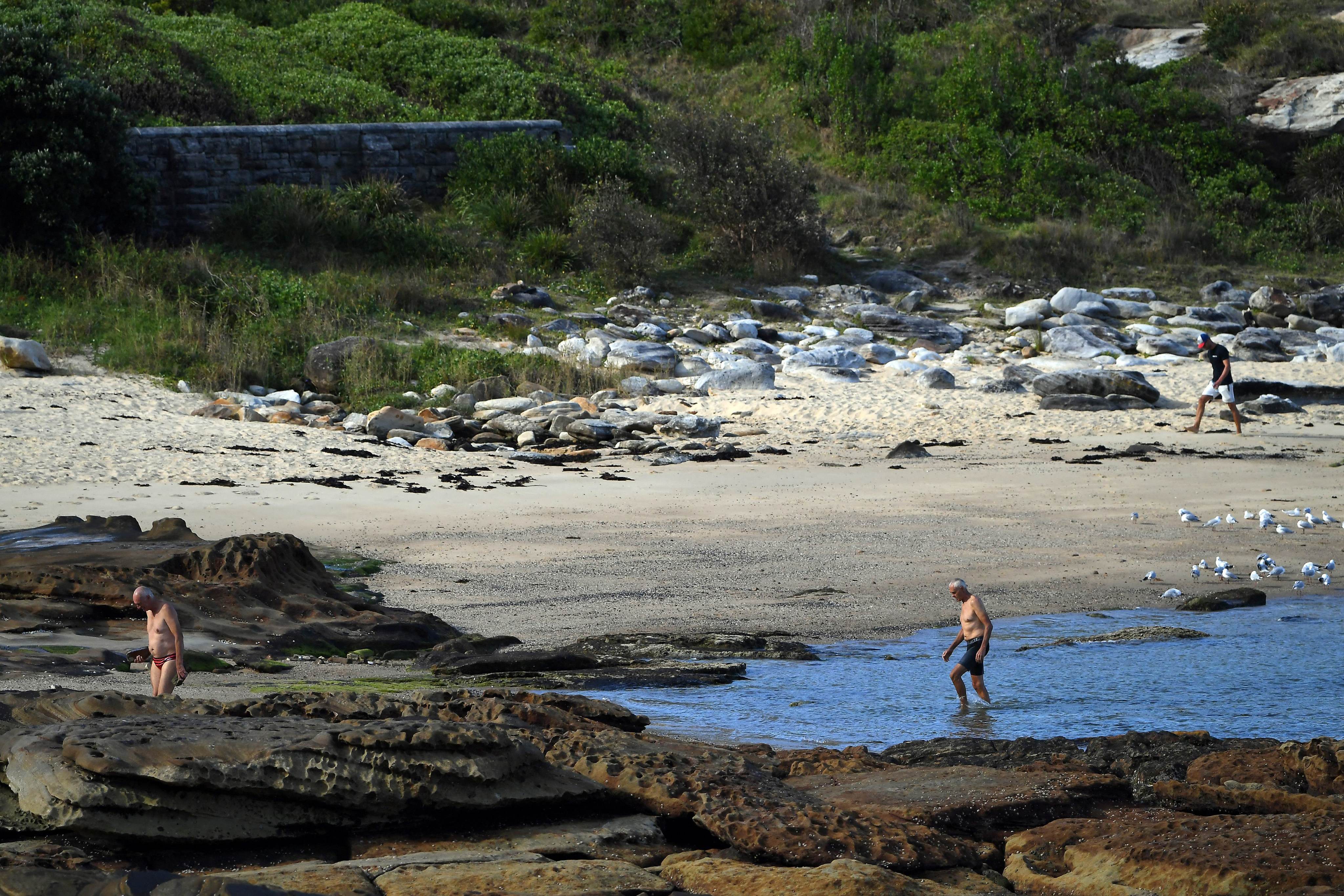 Elderly men walk along a beach in Sydney. In Sydney, only 4 per cent of single retirees relying on income support can afford to rent a one-bedroom home, according to a new report. Photo: AFP