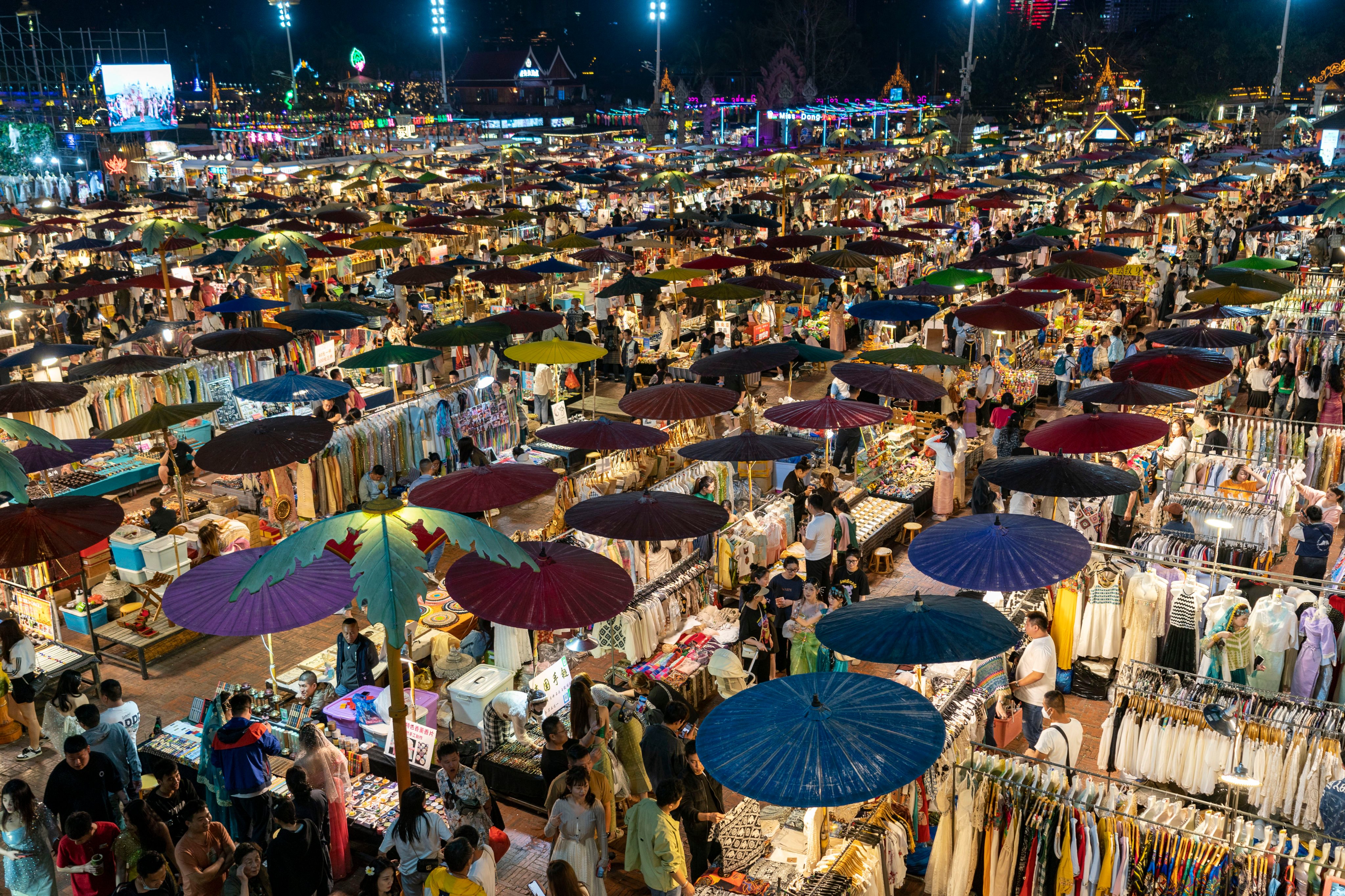 Tourists visit a night fair in the southwestern Chinese city of Jinghong in Xishuangbanna Dai autonomous prefecture in February 2023. Photo: Xinhua