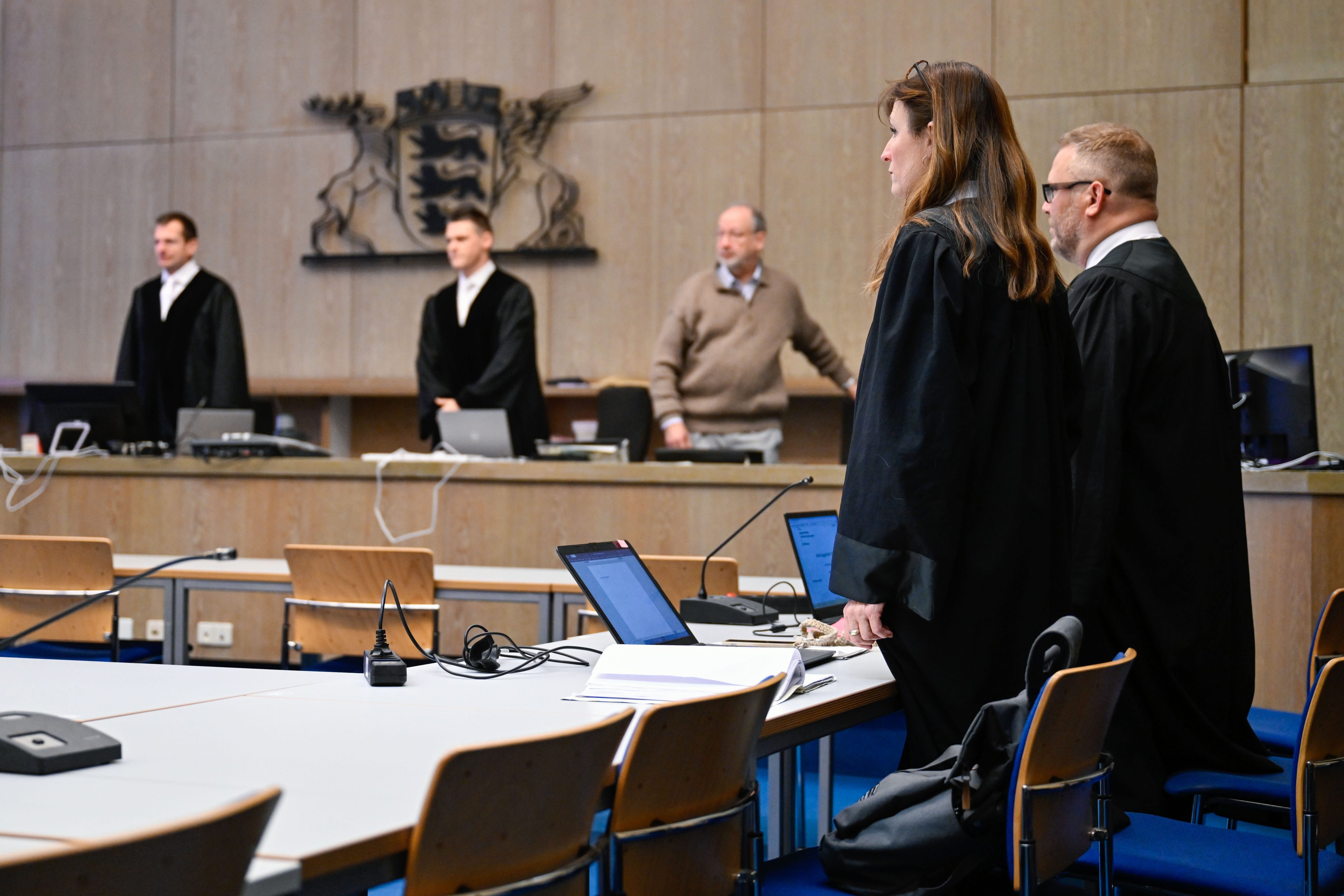 Lawyers Joerg Becker and Sandra Bauer stand in court as the trial begins, with the defendants absent. Photo: dpa