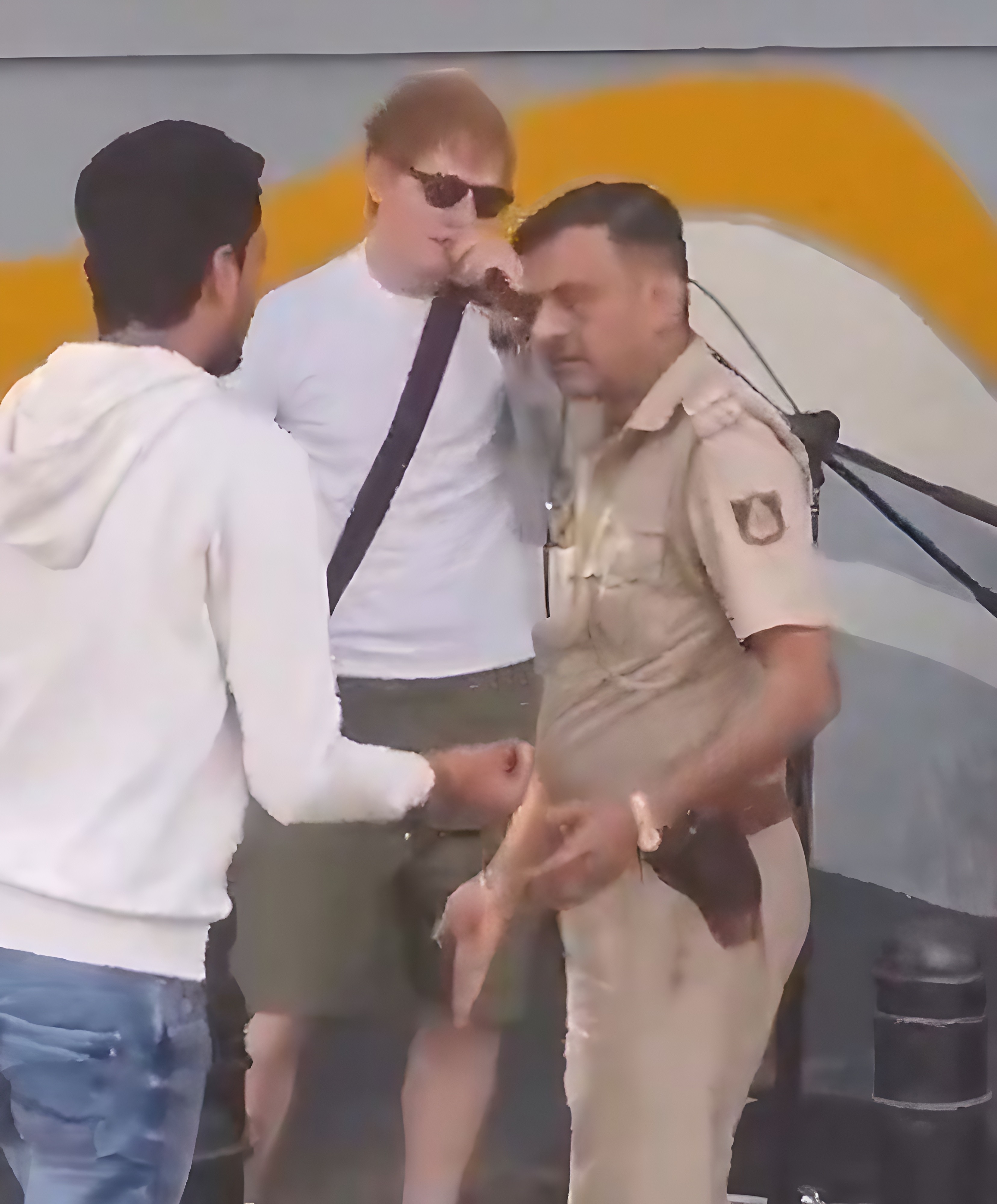 British singer Ed Sheeran reacts after an Indian policeman unplugged his microphone amid an impromptu street performance in Bengaluru on February 9, 2025. Photo: X/aaraynsh