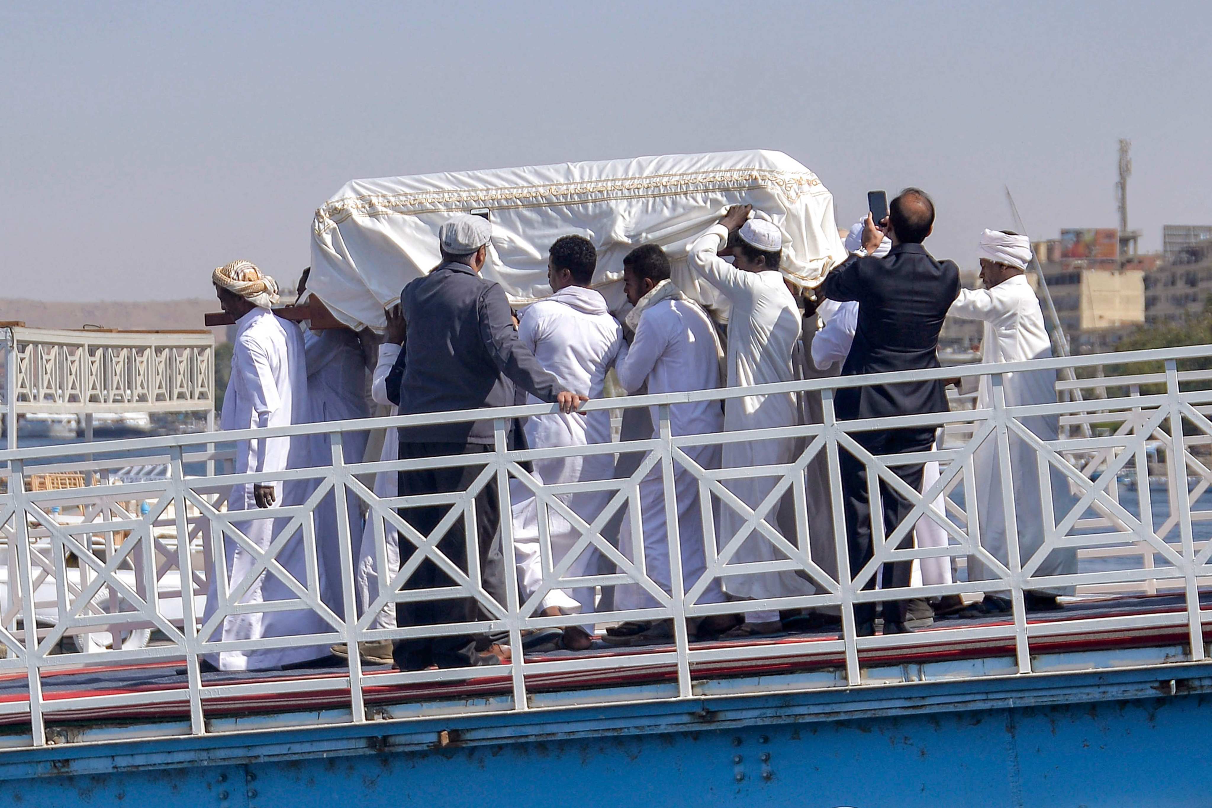 The coffin of Prince Karim al-Husseini, Aga Khan IV, the 49th imam and spiritual leader of Shia Ismaili Muslims, is unloaded off a boat to be buried at the Aga Khan Mausoleum on the west bank of the Nile river in Egypt’s southern city of Aswan on Sunday. Photo: AFP