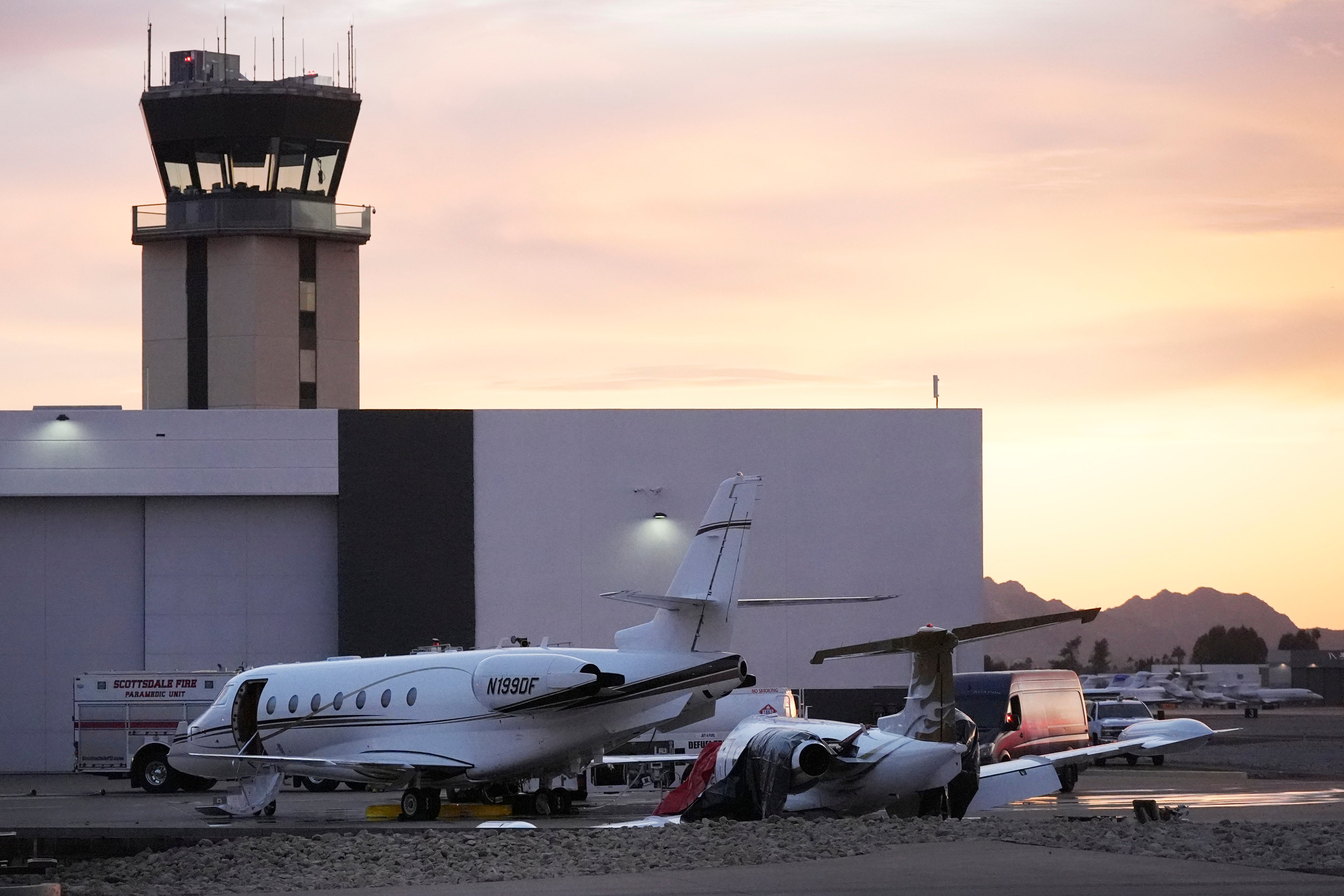 A damaged Learjet, right, after colliding with a parked jet at Scottsdale Airport, Arizona. Photo: AP Photo