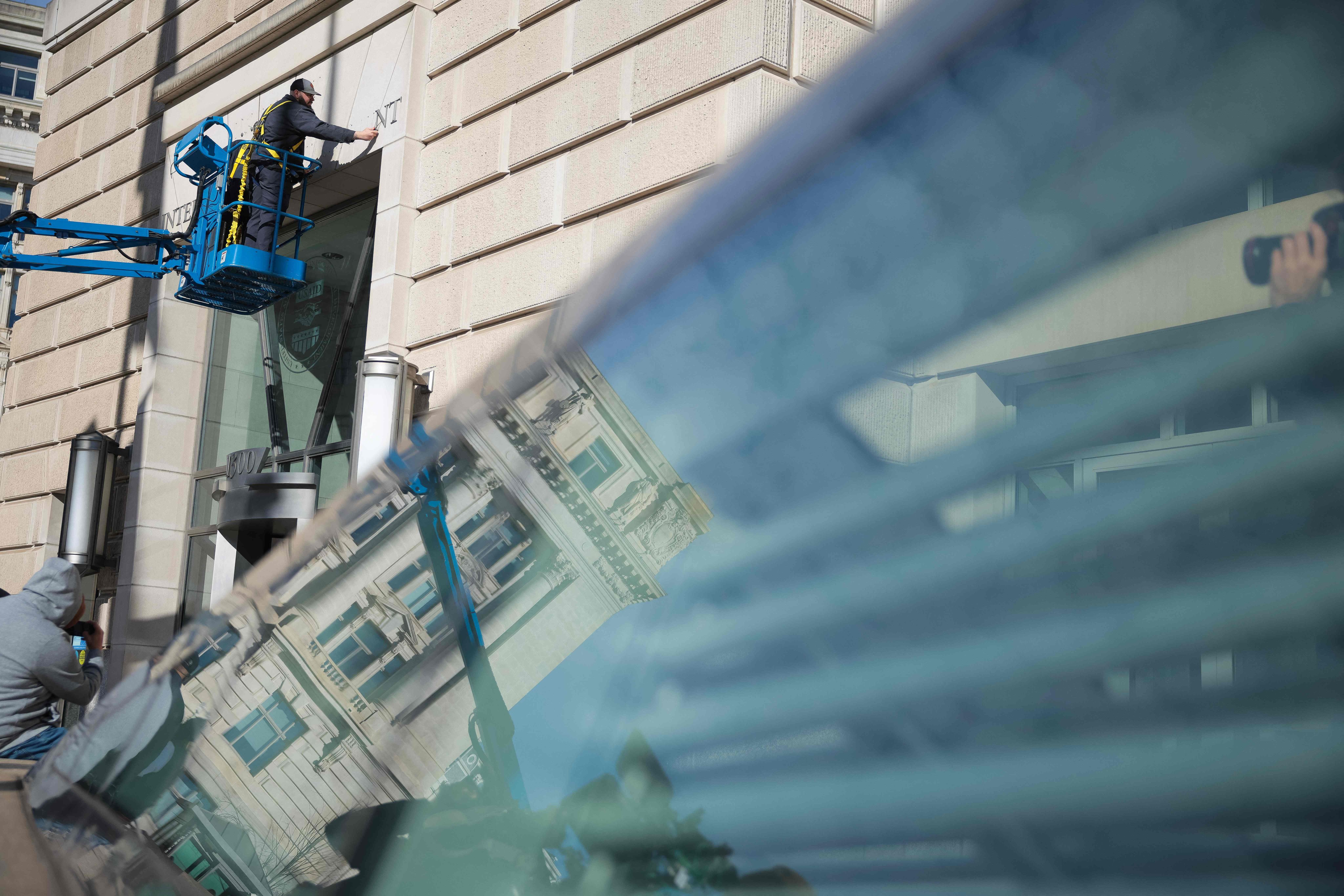 The sign for the US Agency for International Development at its headquarters in Washington is removed on Friday. Photo: Getty Images via AFP