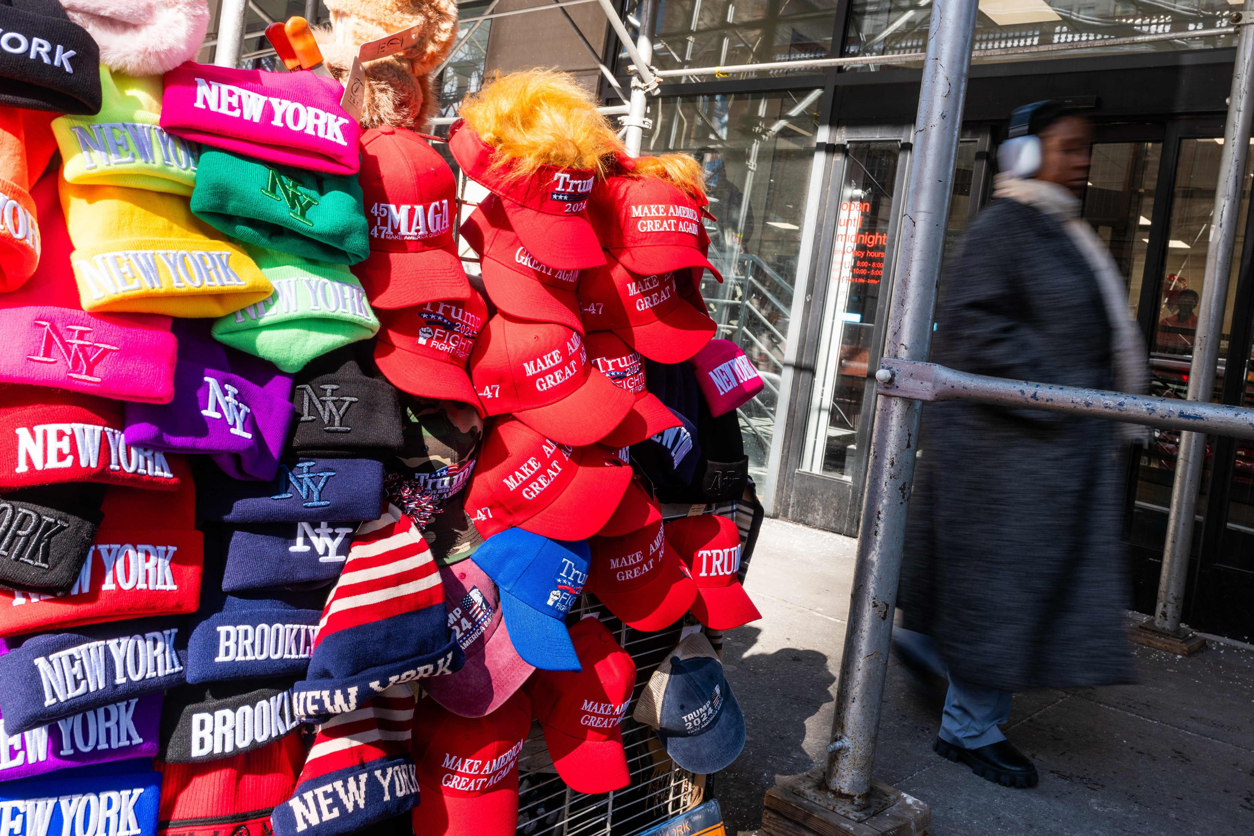 Hats supporting Donald Trump are displayed for sale near the New York Stock Exchange on February 10. Photo: Getty Images via AFP