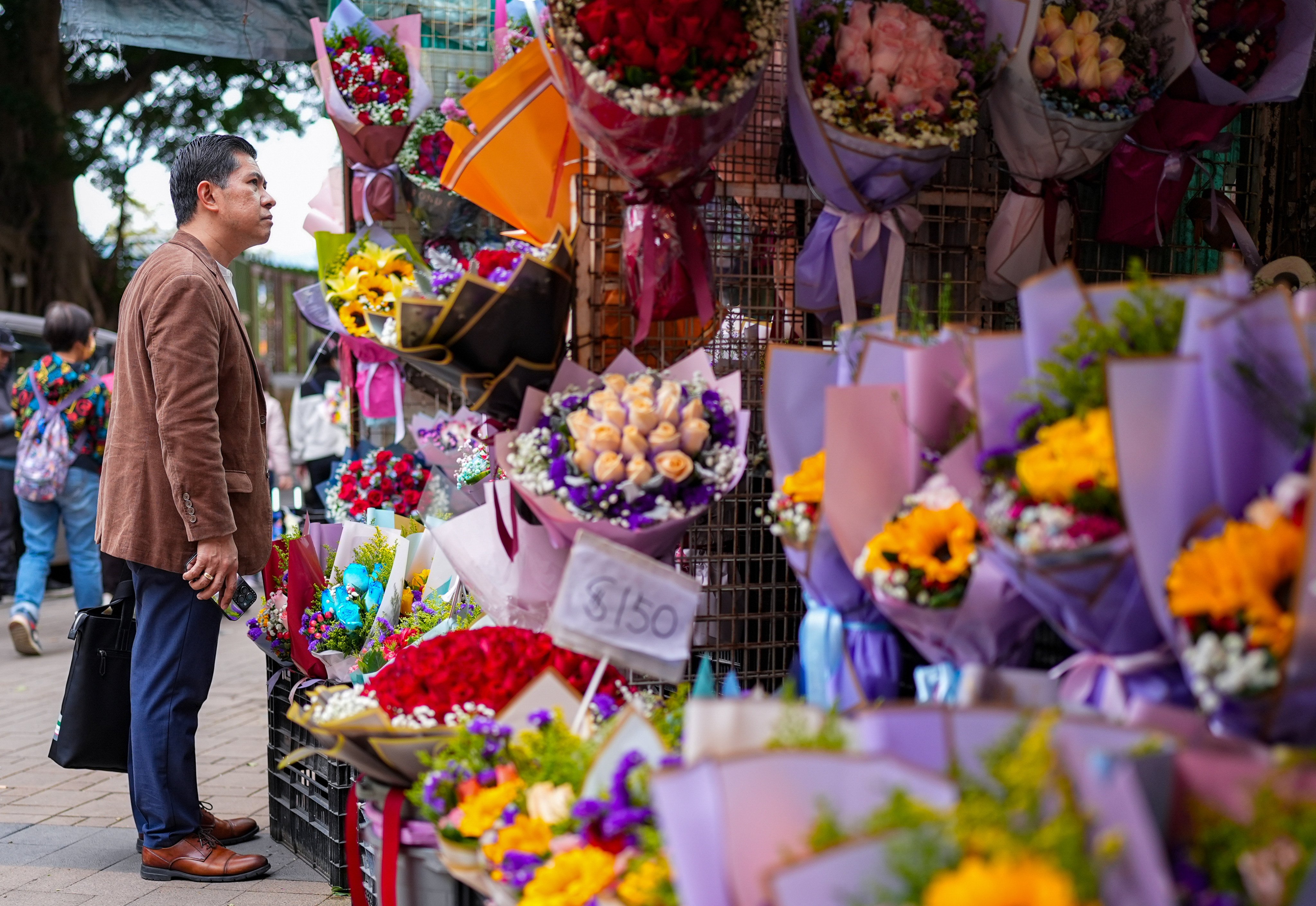 A man browses flowers at a market in Mong Kok ahead of Valentine’s Day. Photo: Eugene Lee