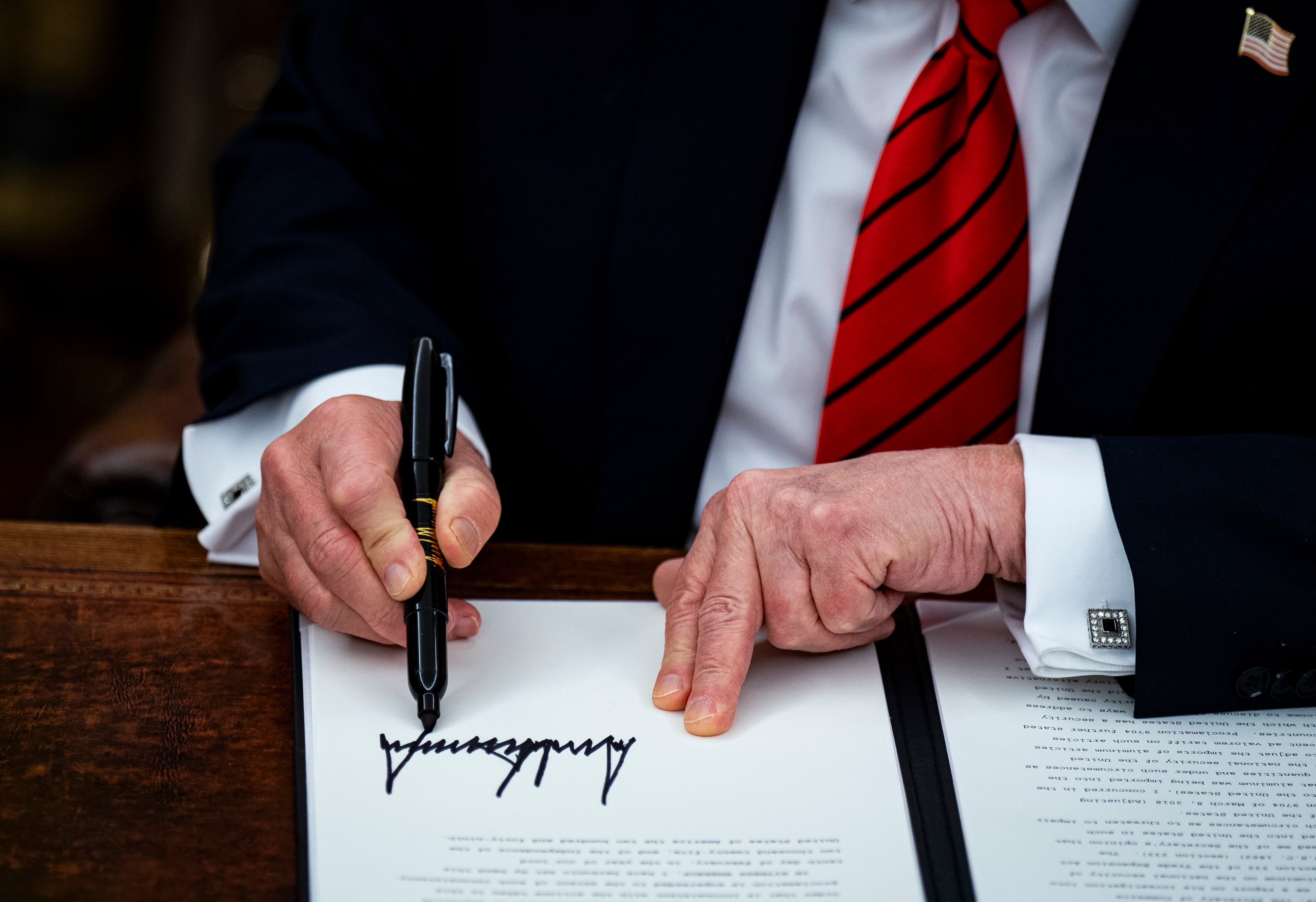 US President Donald Trump signs an executive order in Washington on Monday imposing 25 per cent tariffs on all steel and aluminium imports. Photo: EPA-EFE