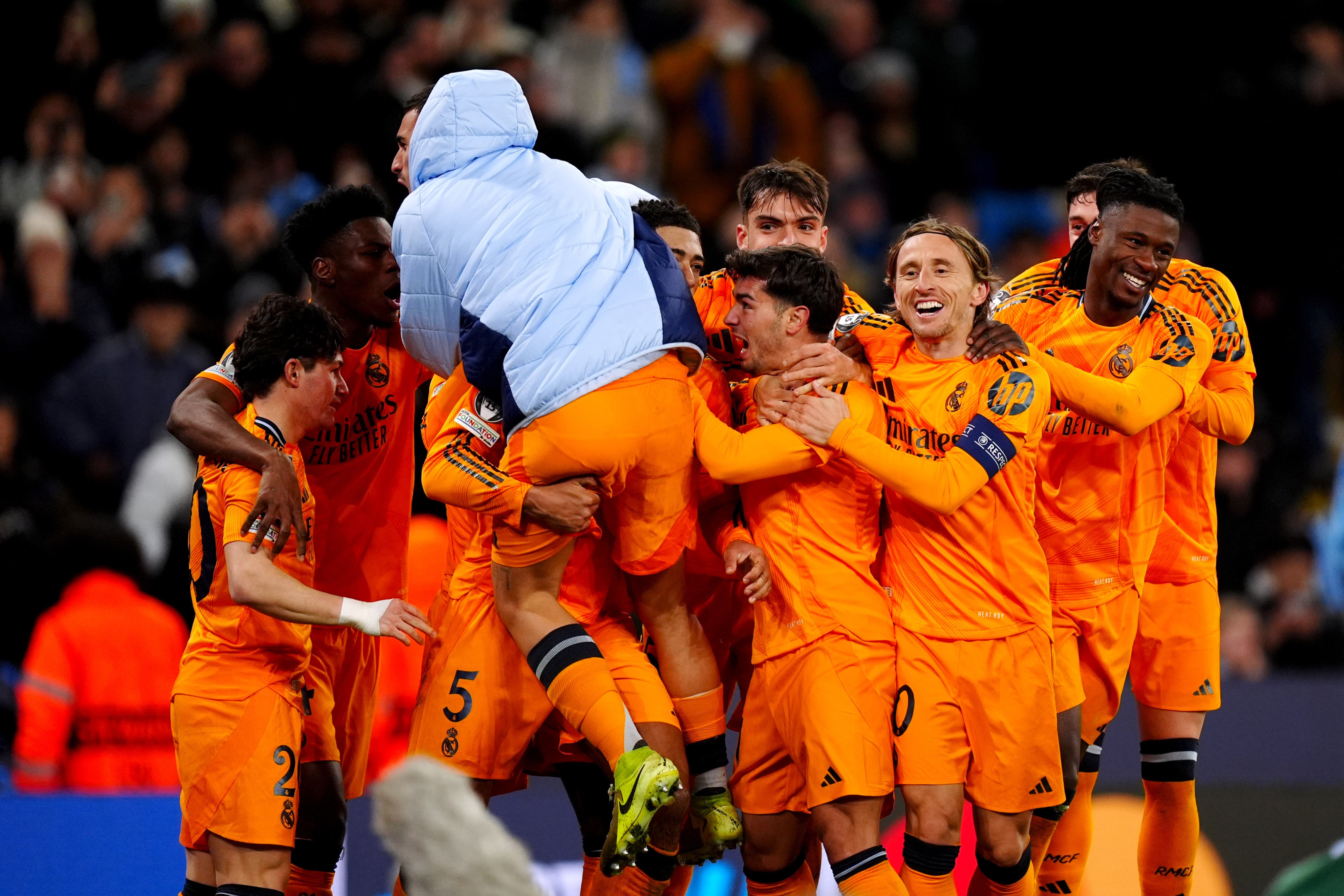 Real Madrid players celebrate together after Jude Bellingham’s last-gasp winner in the Champions League against Manchester City. Photo: dpa