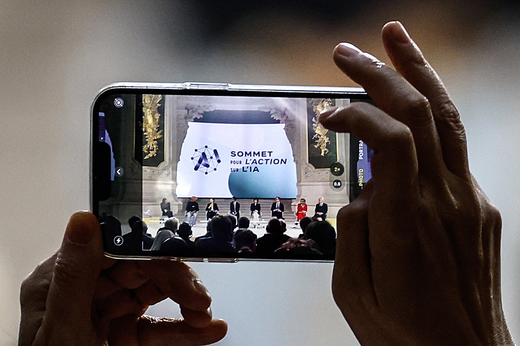 A participant takes a photo during a plenary session of the Artificial Intelligence (AI) Action Summit at the Grand Palais in Paris, France, on February 11.  Photo: EPA-EFE