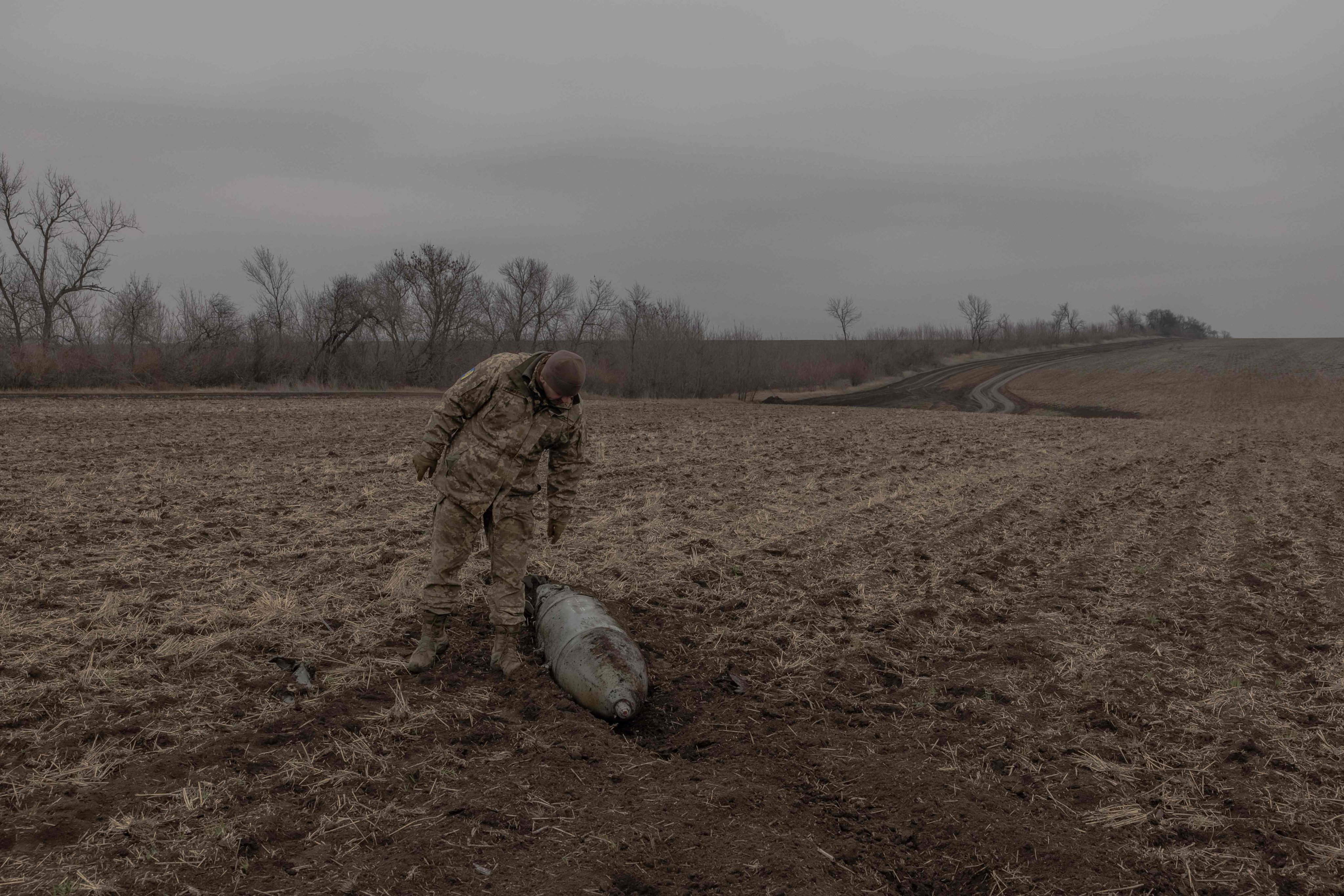 A Ukrainian military deminer checks an unexploded Russian aerial guided bomb in a field in the Dnipropetrovsk region, Ukraine. Photo: AFP