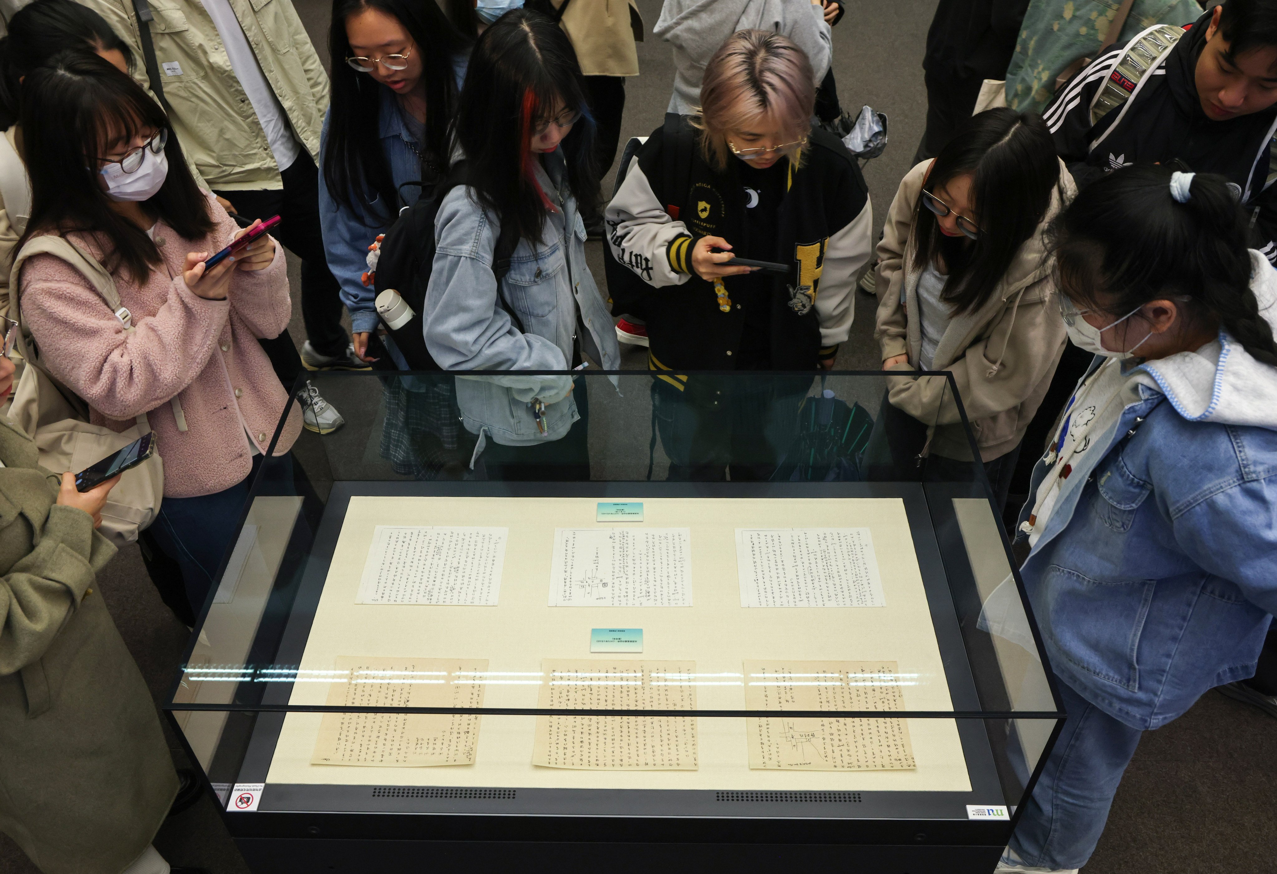 Hong Kong Metropolitan University students take a look at some of Eileen Chang’s manuscripts. Photo: Jelly Tse