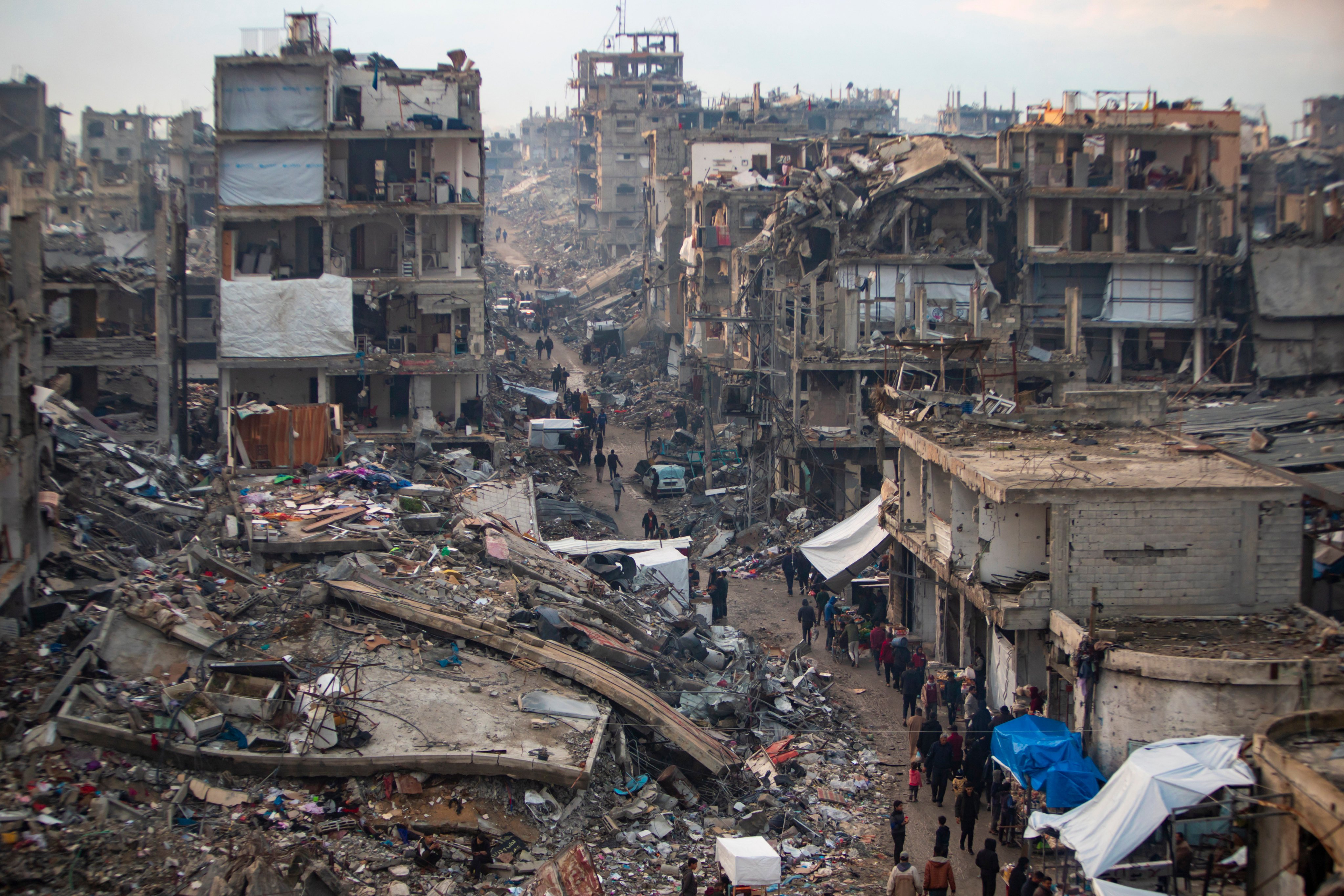 Palestinians walk in the destruction caused by the Israeli air and ground offensive in Jabaliya, Gaza Strip. Photo: AP