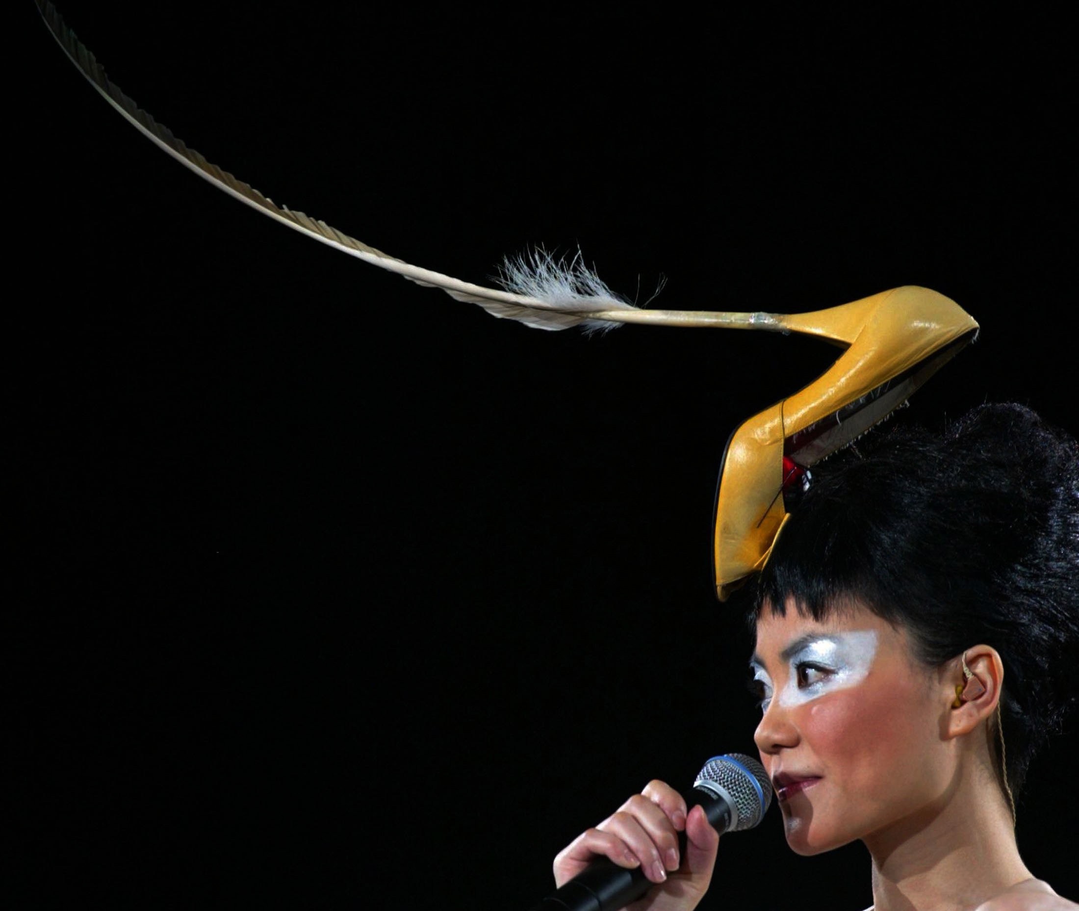 Hong Kong singer-actress Faye Wong, wearing a high heel hat, performs in Hong Kong in  2003. Twice married and twice divorced, Wong walked away from her career in 2005, and has appeared only sporadically on stage since then. Photo: Reuters