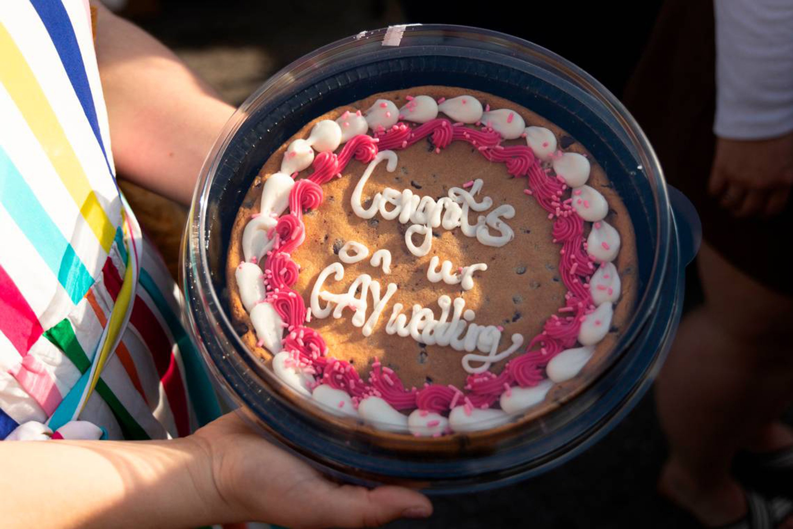 Friends of Christine Fowler and Sharon Thrailkill present a cookie cake to the couple at Y’­all-Mart, in Columbia, South Carolina. Photo: TNS