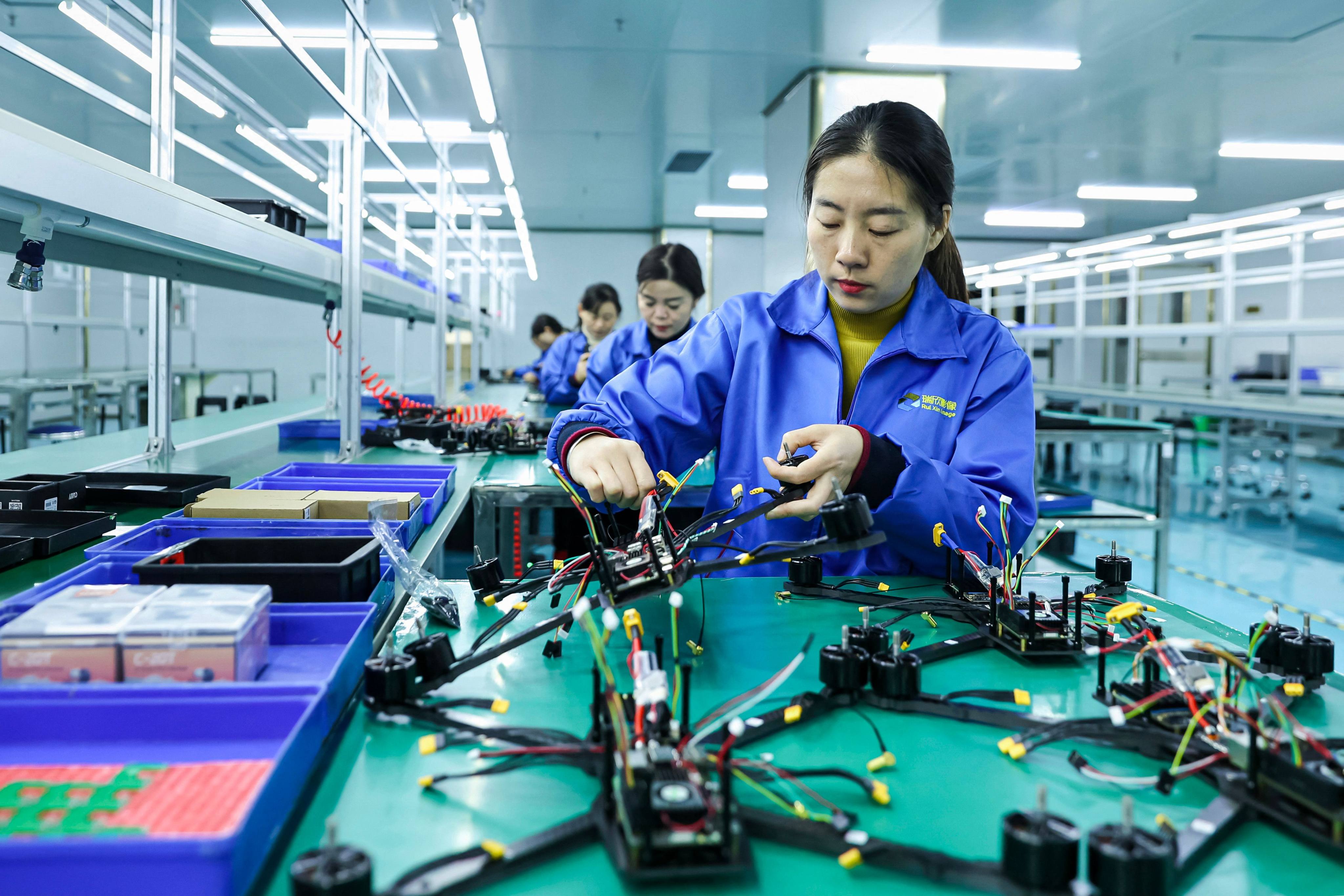 Employees make drones intended for export at a factory in Ruichang, Jiangxi province on November 27, 2024. Photo: AFP