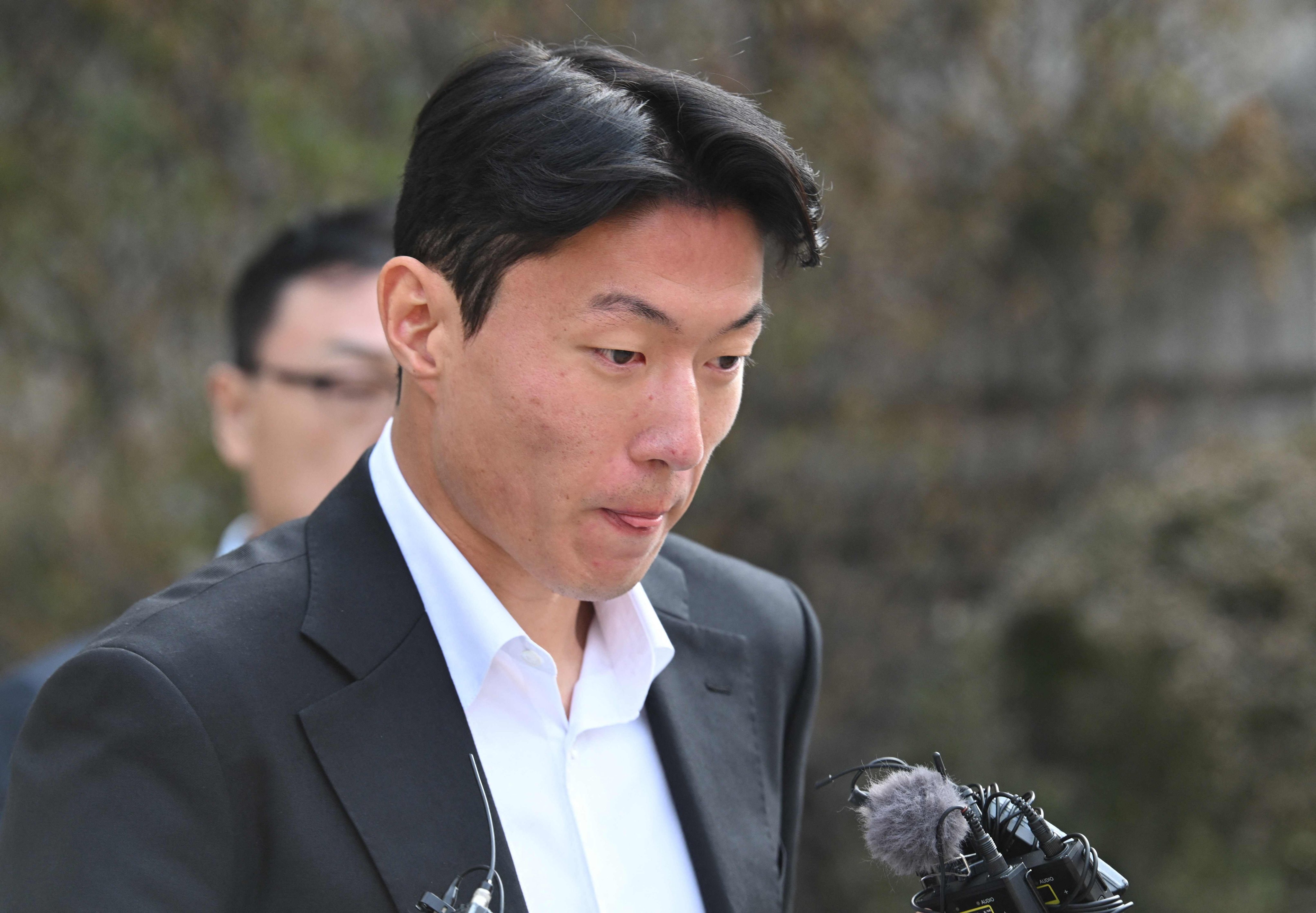 Hwang Ui-jo leaves court in Seoul on Friday after sentencing over his sex-video scandal. Photo: AFP