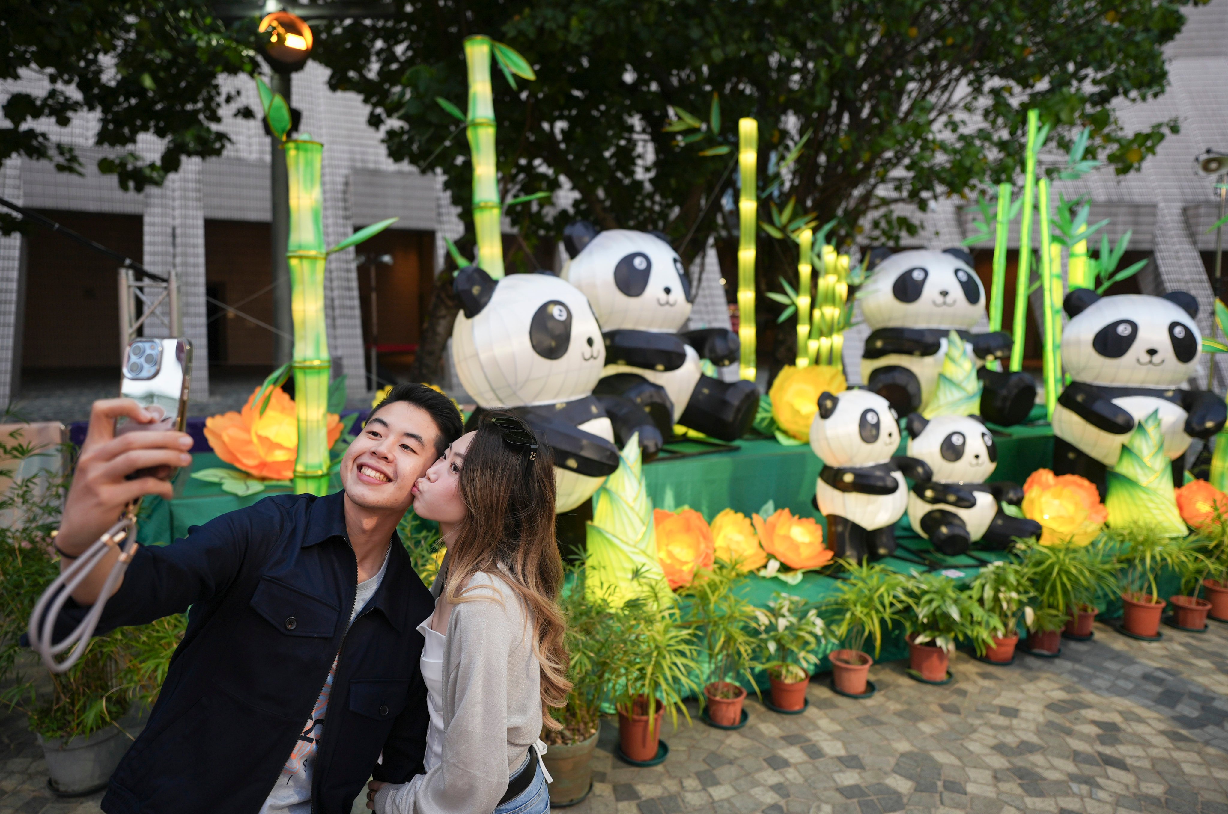 A couple poses in front of panda lanterns at the Hong Kong Cultural Centre. Photo: Eugene Lee