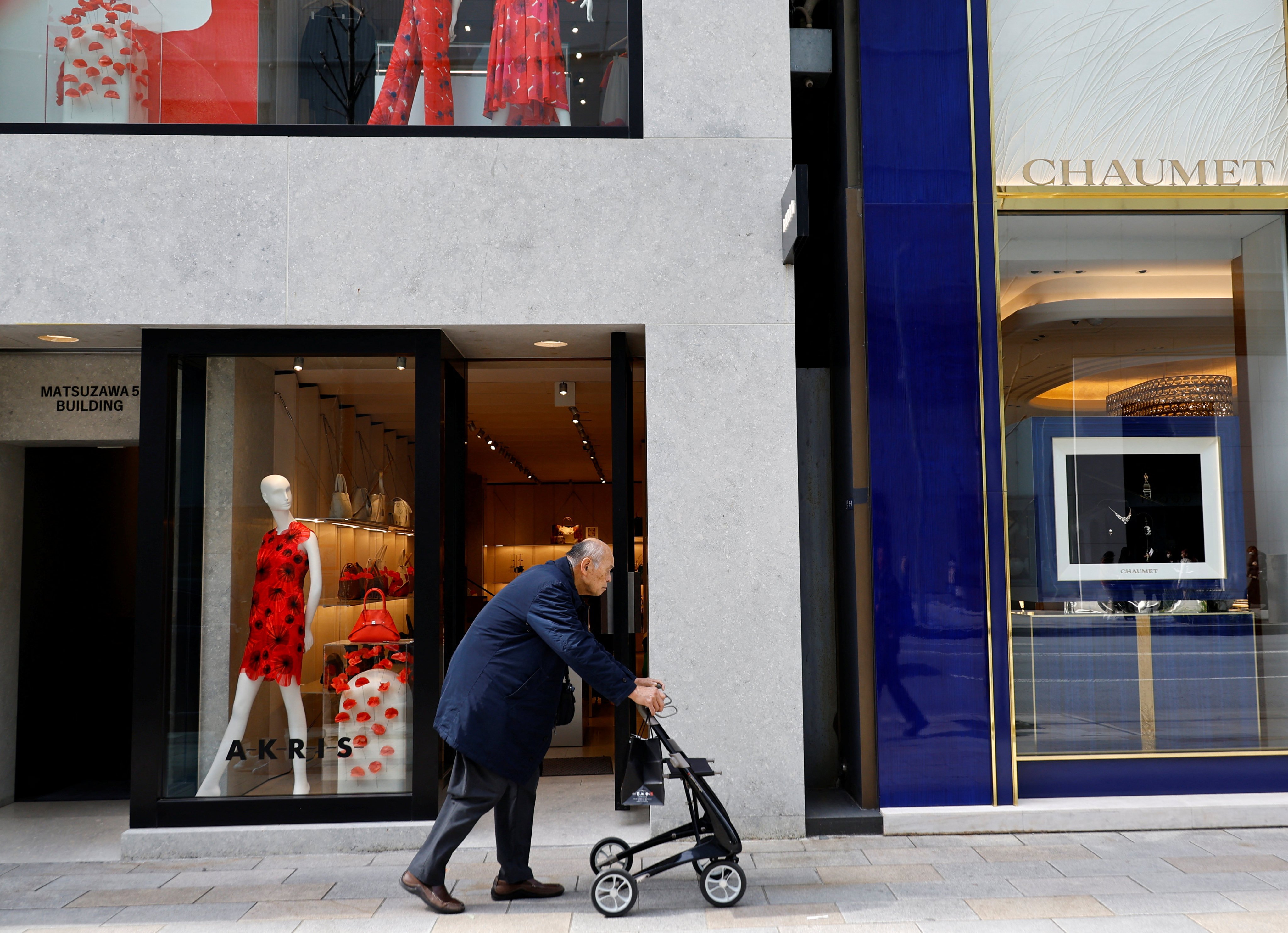 An elderly man walks through a shopping district in Tokyo, Japan. Photo: Reuters