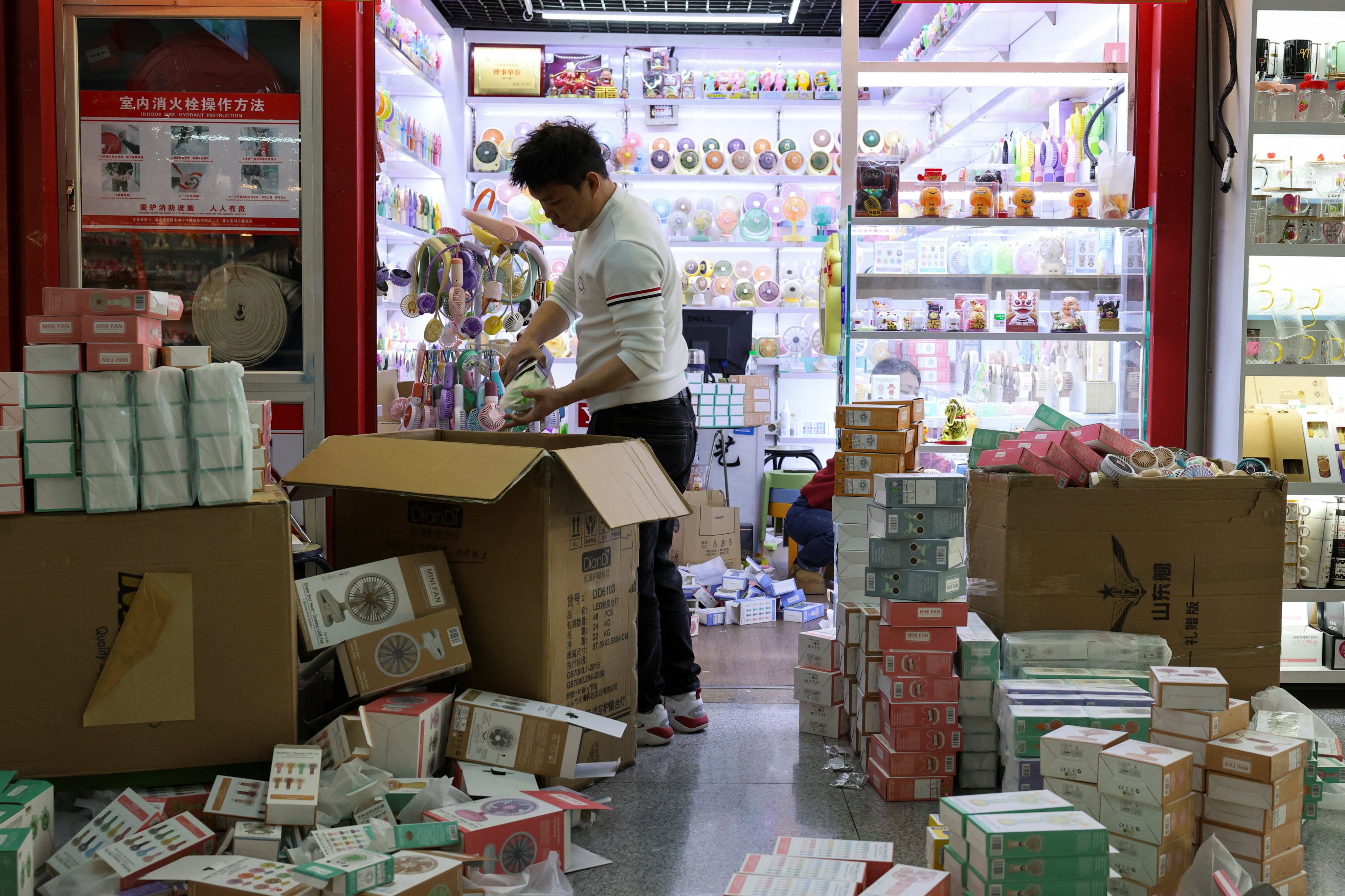 A vendor unpacks merchandise at the vast wholesale market in Yiwu, Zhejiang province. Photo: Reuters