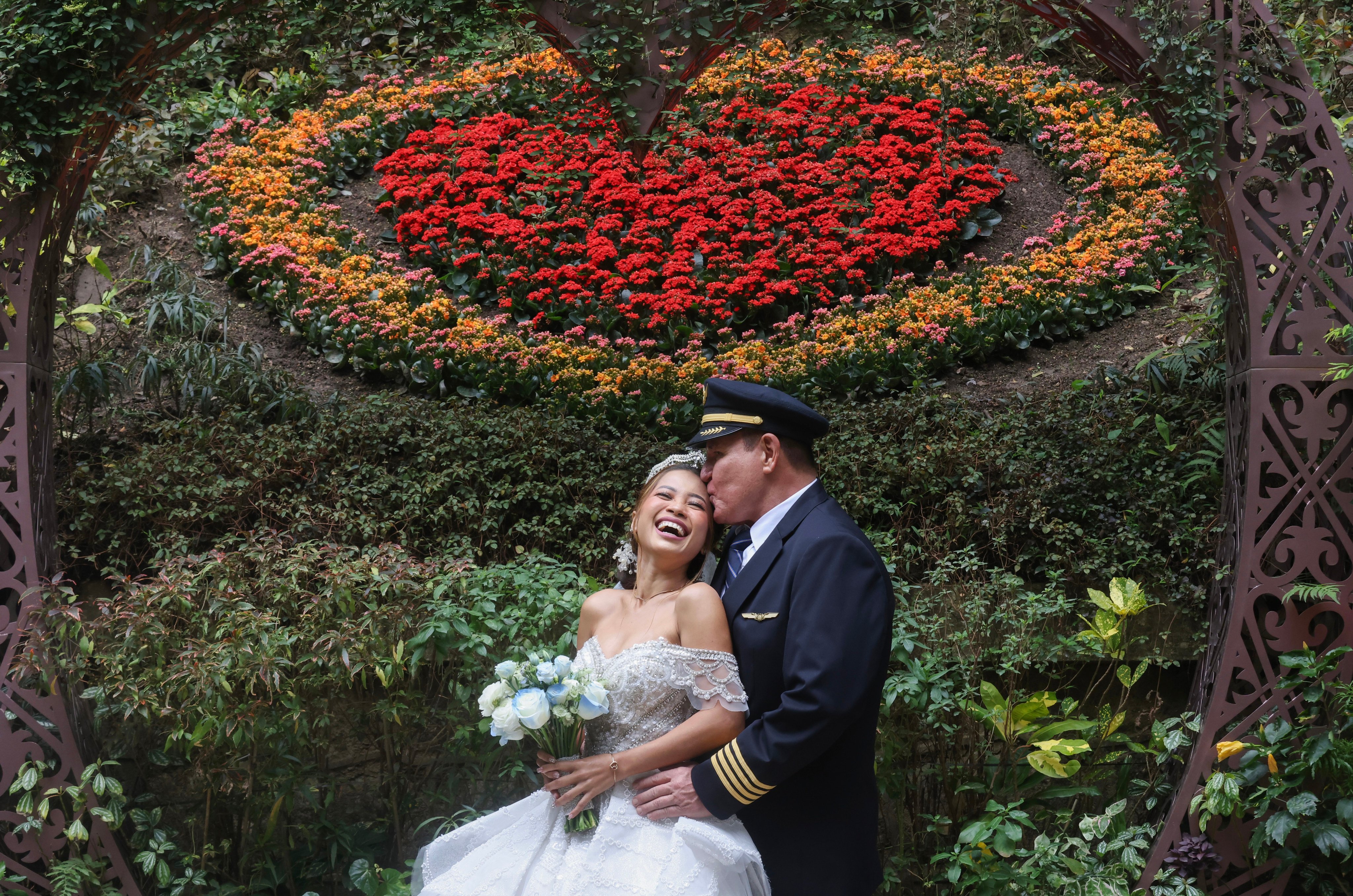 Newlyweds pose for pictures at Hong Kong Park on Valentine’s Day. Photo: Jonathan Wong