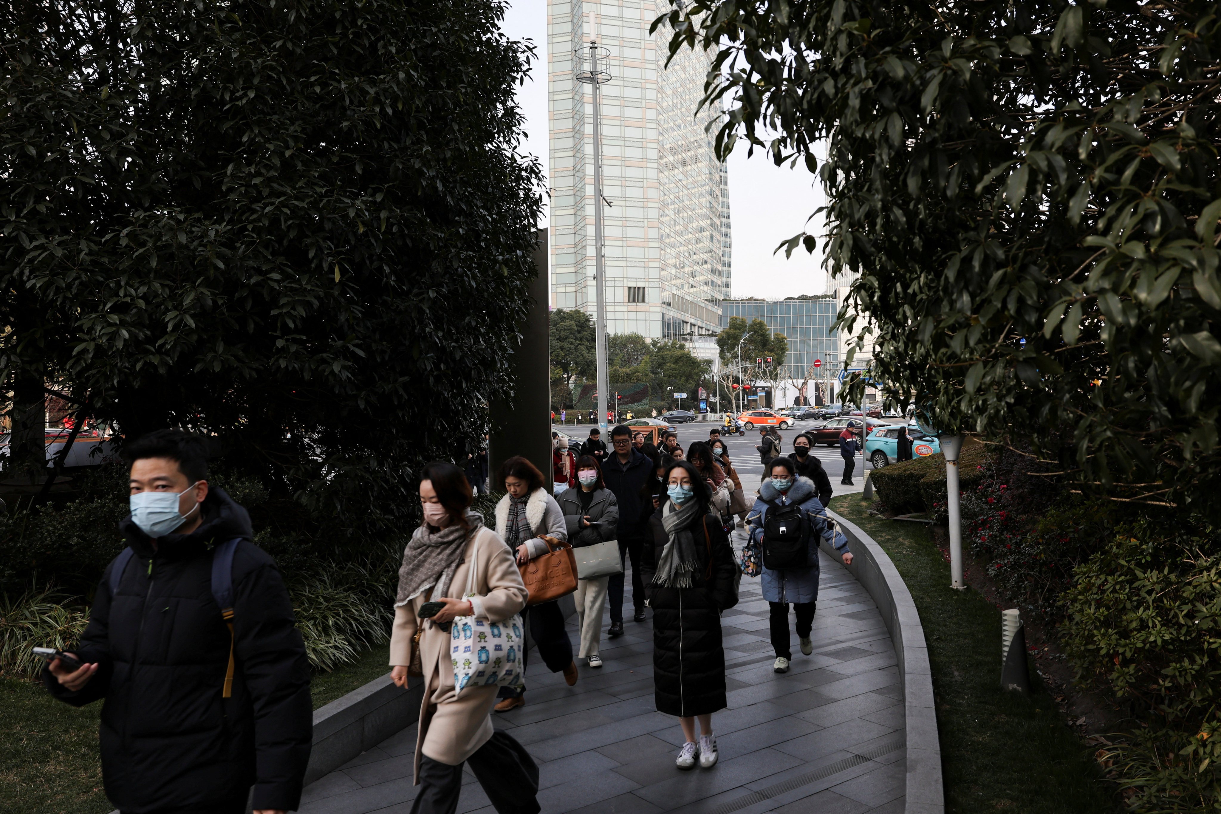 People walk in the Pudong financial district in Shanghai on February 5, 2025. Photo: Reuters