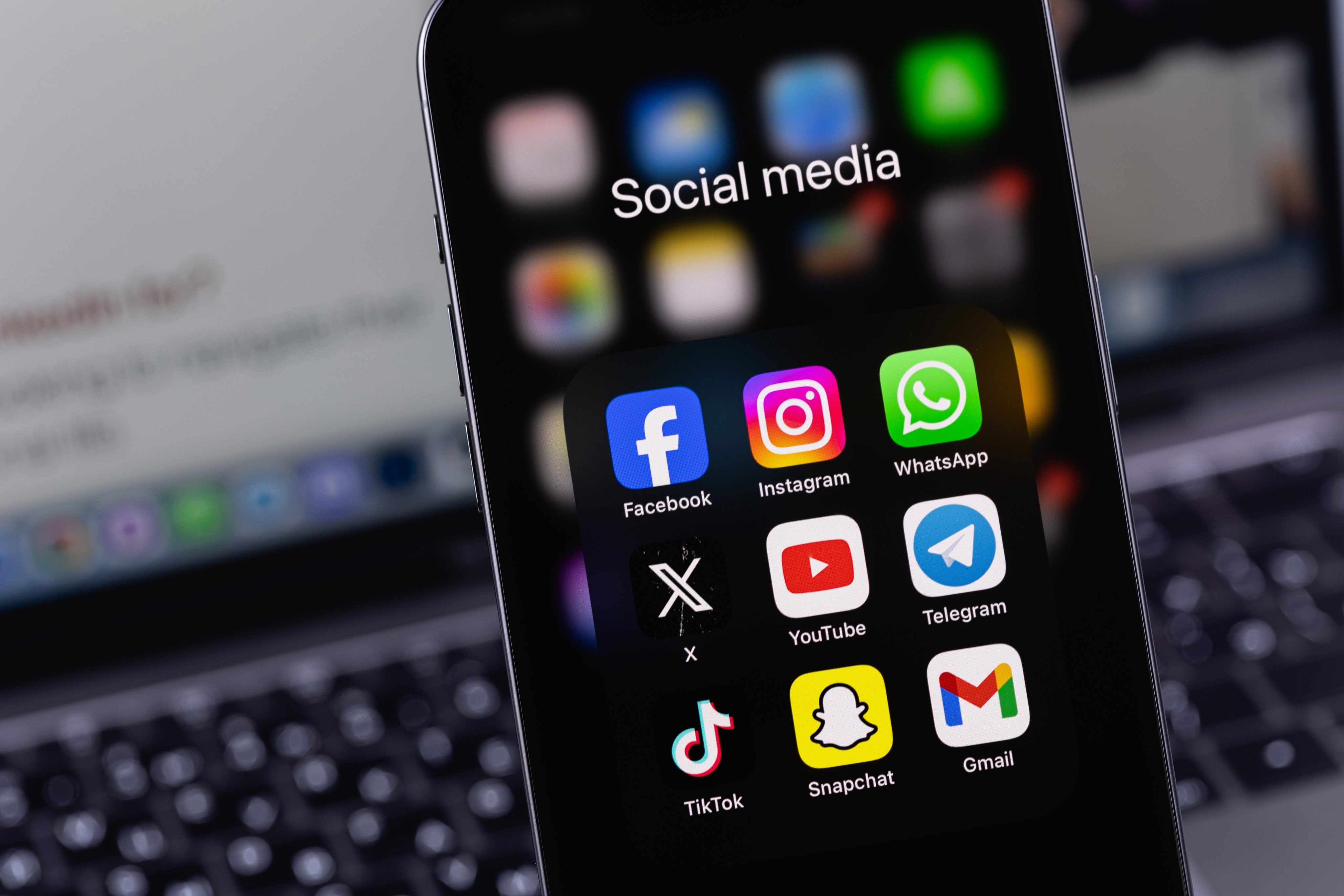 A smartphone showing social media apps including Facebook, Instagram, X, TikTok and Snapchat. Photo: Shutterstock