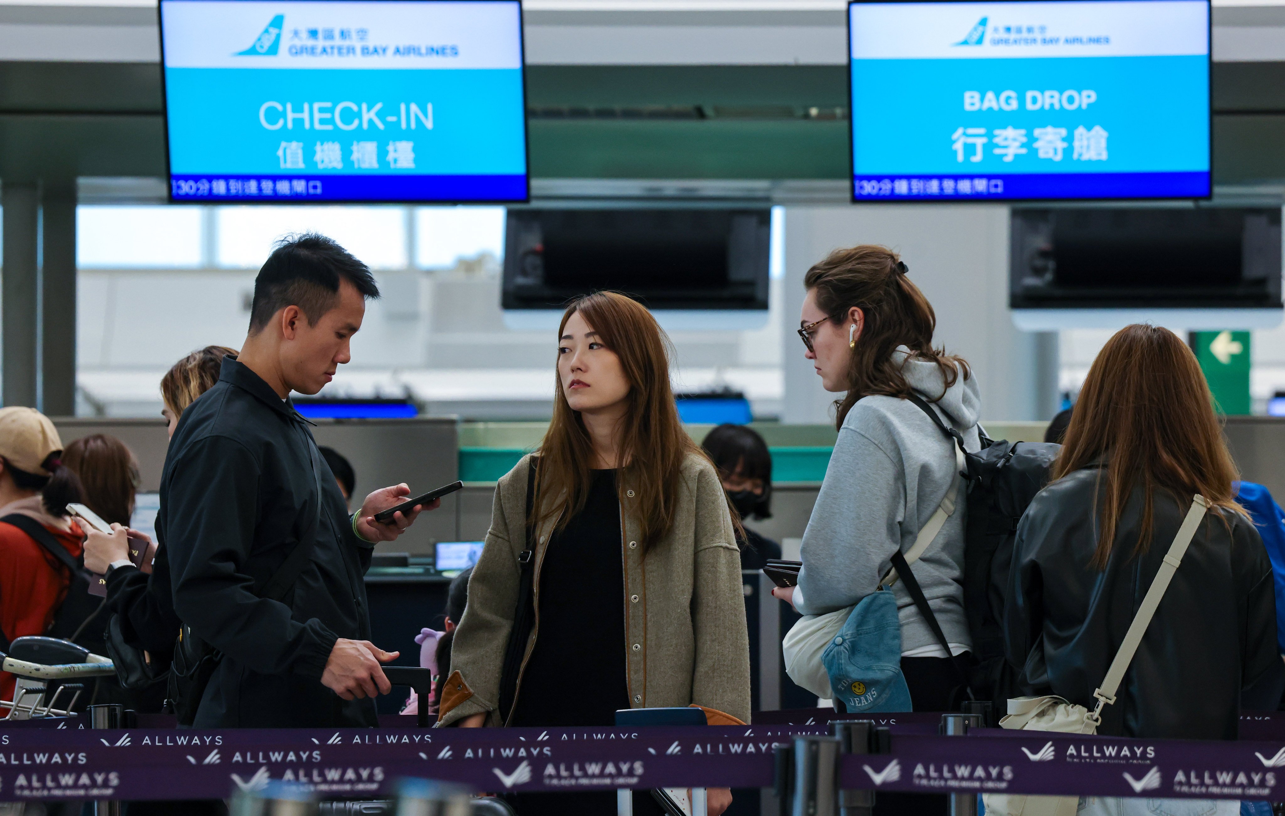 Passengers queue at a Greater Bay Airlines counter at Hong Kong International Airport. Photo: Jelly Tse