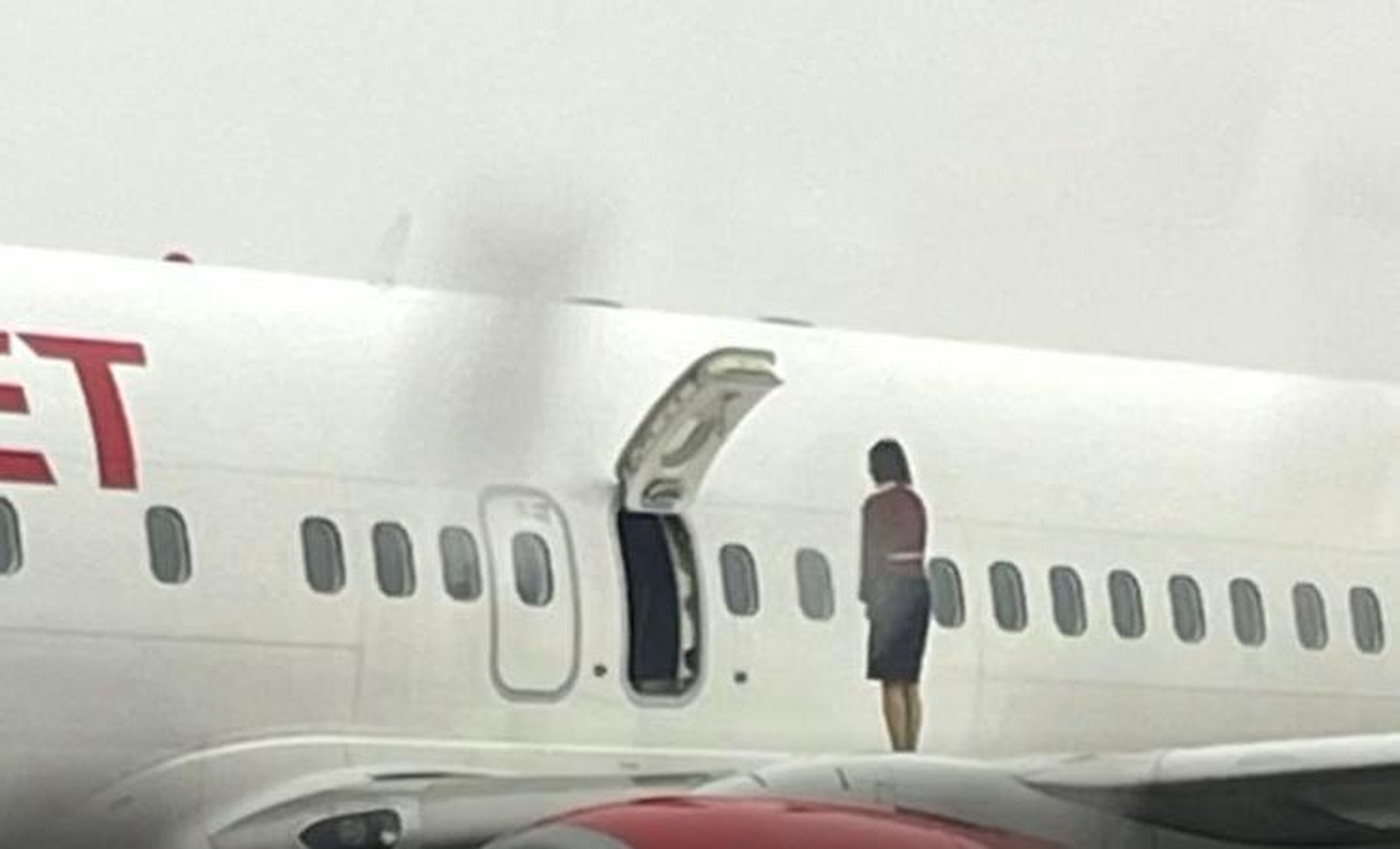 A crew member of an Eastar Jet flight stands on the wing of an aircraft at Cheongju Airport. Photo: JTBC