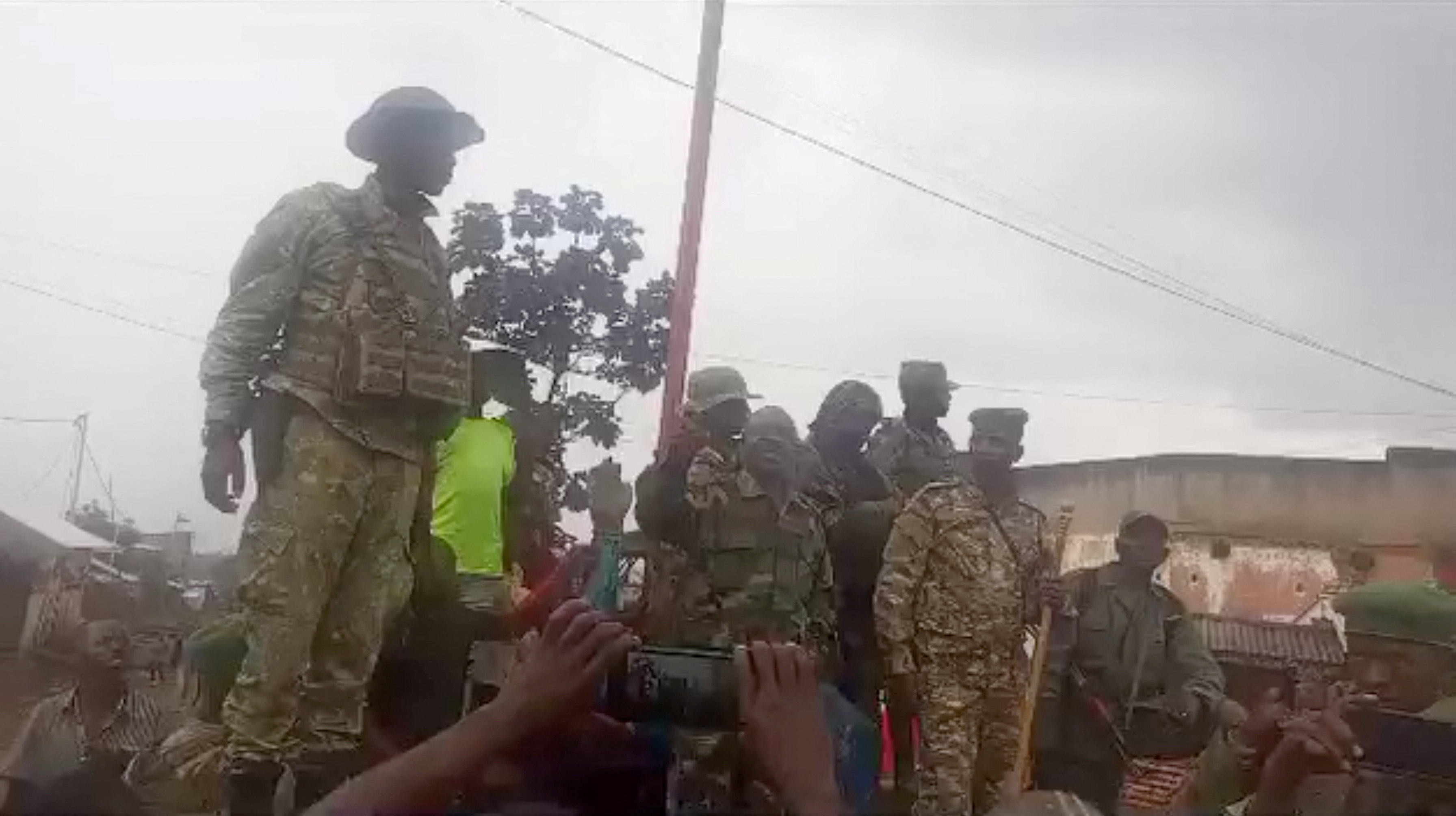 A person in military clothing speaks to a gathered crowd in Katana, a town near Kavumu airport that has been captured by M23 rebels. Photo: Social media via Reuters
