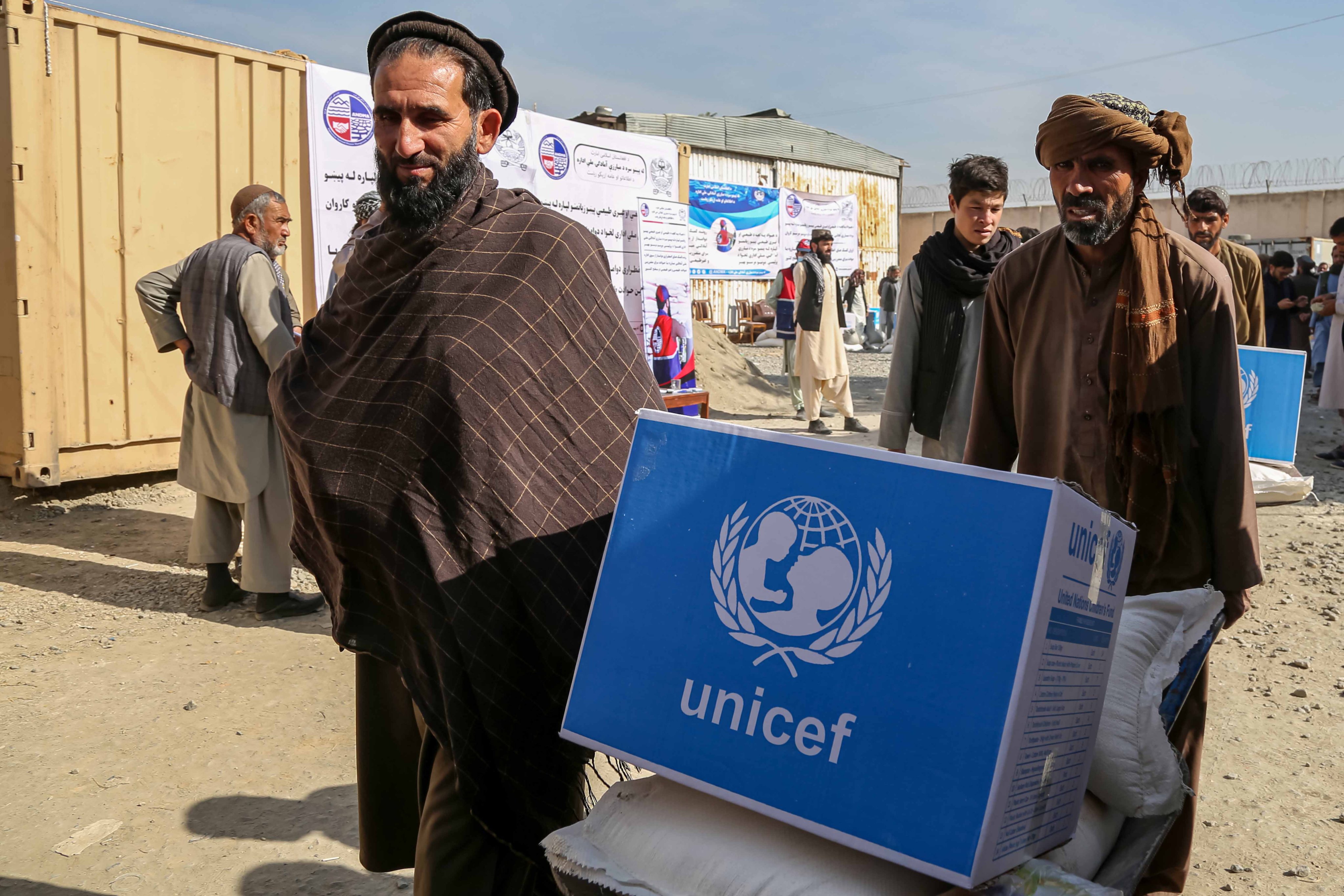 Afghans receiving UN-sponsored rations distributed by the National Disaster Preparedness Office in Kabul, on Thursday. Photo: EPA-EFE