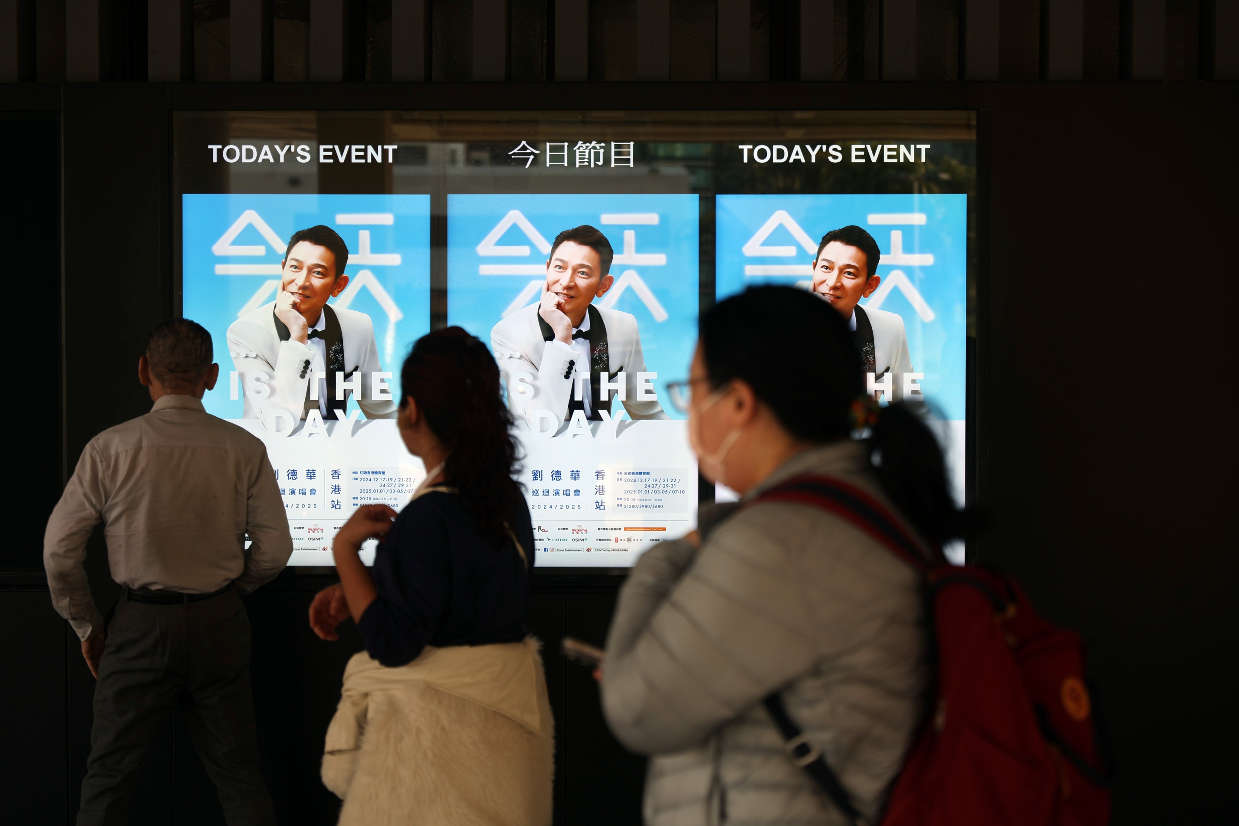 People walk past a poster featuring pop singer Andy Lau outside the Hong Kong Coliseum in Hung Hom on December 17, 2024. Photo: Edmond So