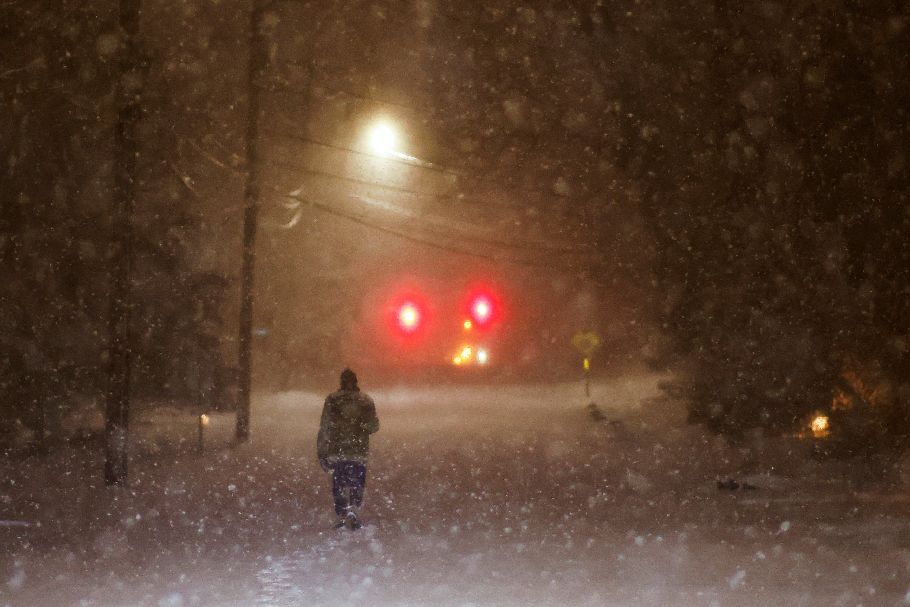 A man walks along an empty road during the pass of a polar vortex in Norwood, New Jersey, on January 19, 2025. Photo: Reuters