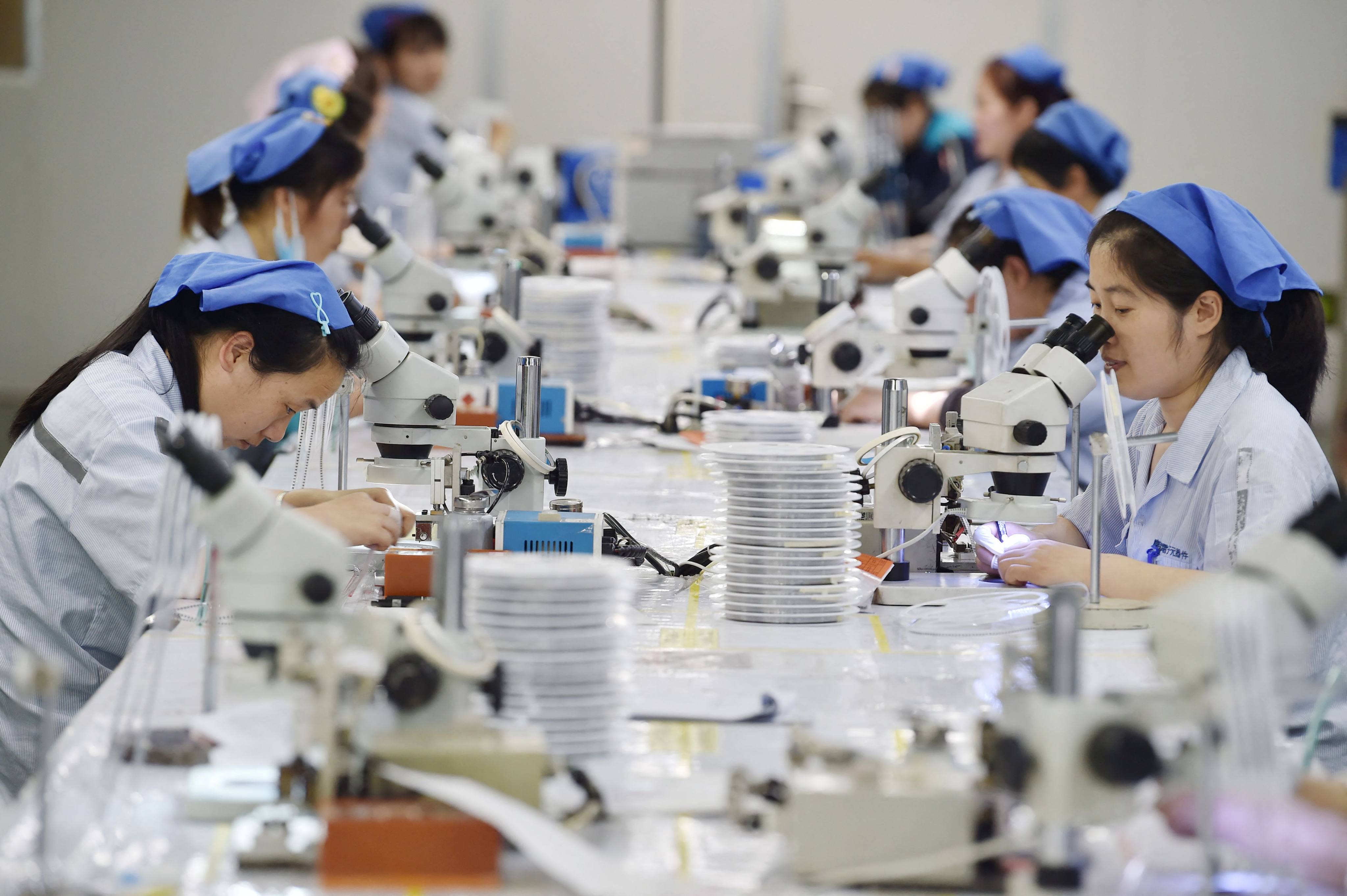 Workers produce electronic components at a factory in Suqian, in Jiangsu province, in 2023. Photo: AFP